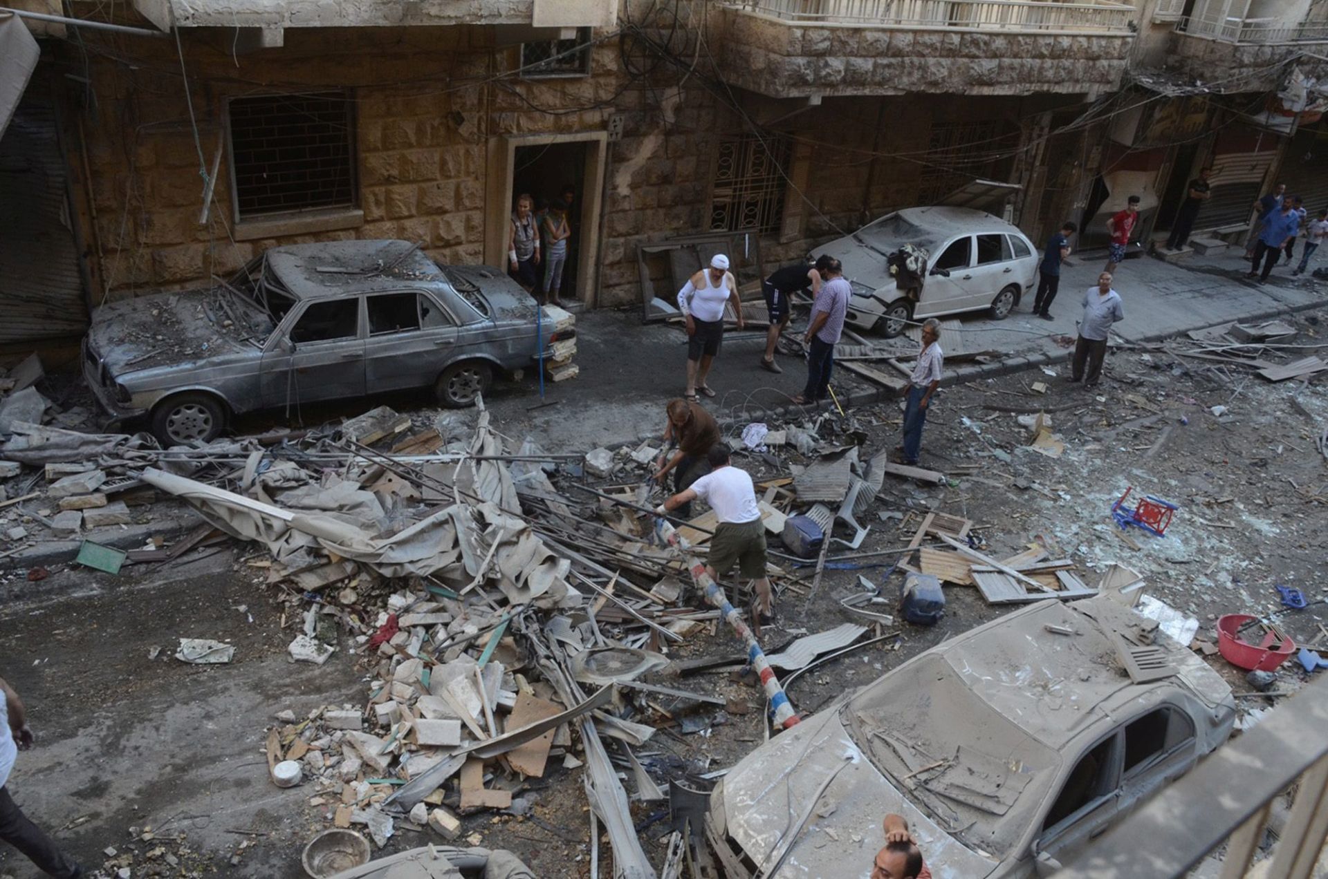 epa05420791 A handout photograph released by the official Syrian Arab News Agency (SANA) shows people inspecting a residential neighborhood after rocket shells attack, in the government-held area of Aleppo, Syria, 11 July 2016. According to SANA, eight people were killed after rocket shells allegedly fired by rebels hit residential neighborhoods in Aleppo.  EPA/SANA HANDOUT  HANDOUT EDITORIAL USE ONLY/NO SALES