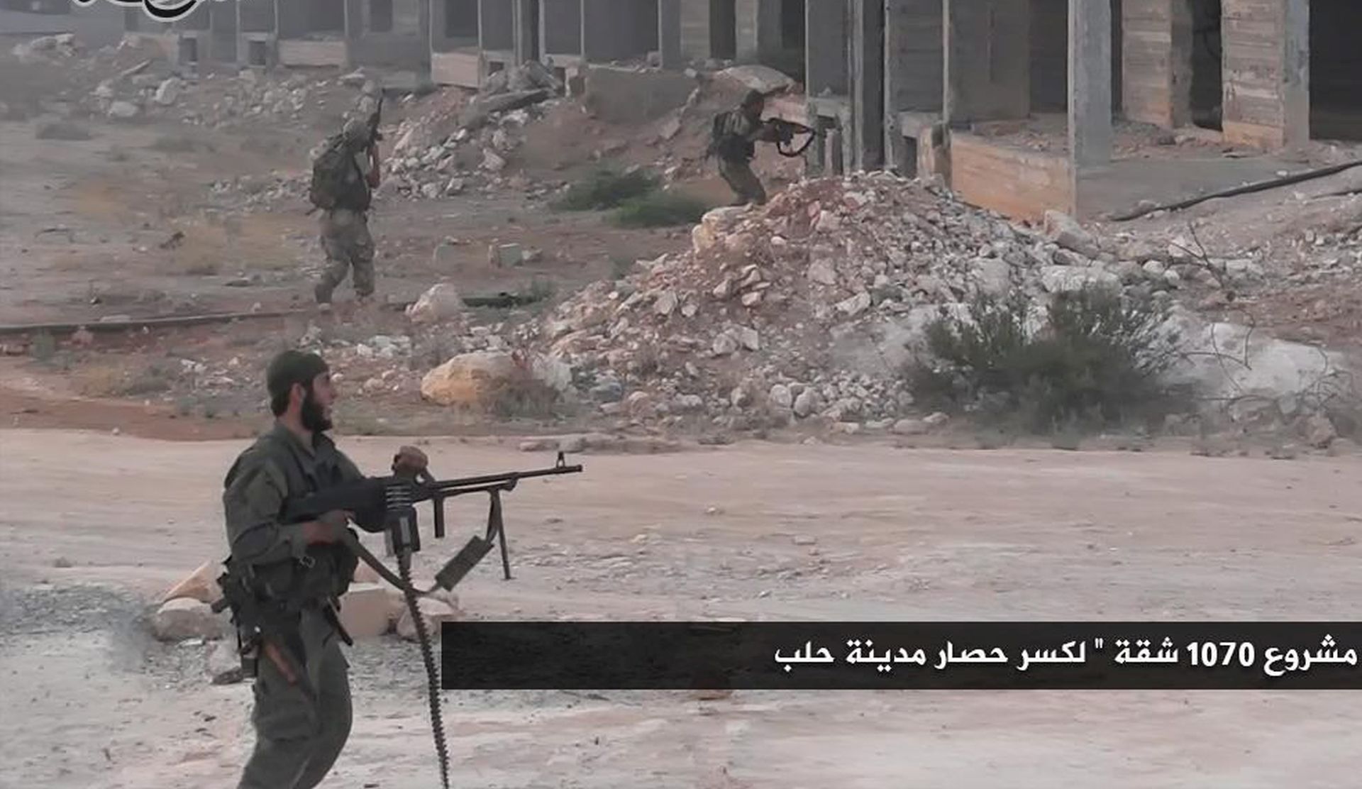 epa05450884 A handout picture made available from Fateh al-Sham front media outlets shows Fateh al-Sham fighters during a battle in Aleppo, Syria, 01 August 2016. According to Fateh al-Sham reports number of surrounding hills in southern Aleppo have been captured by their forces from the Syrian army's hold. The arabic text reads 'Fighters enters the 1070 apartments project during the battle of Aleppo'.  EPA/FATEH AL-SHAM HANDOUT  HANDOUT EDITORIAL USE ONLY/NO SALES