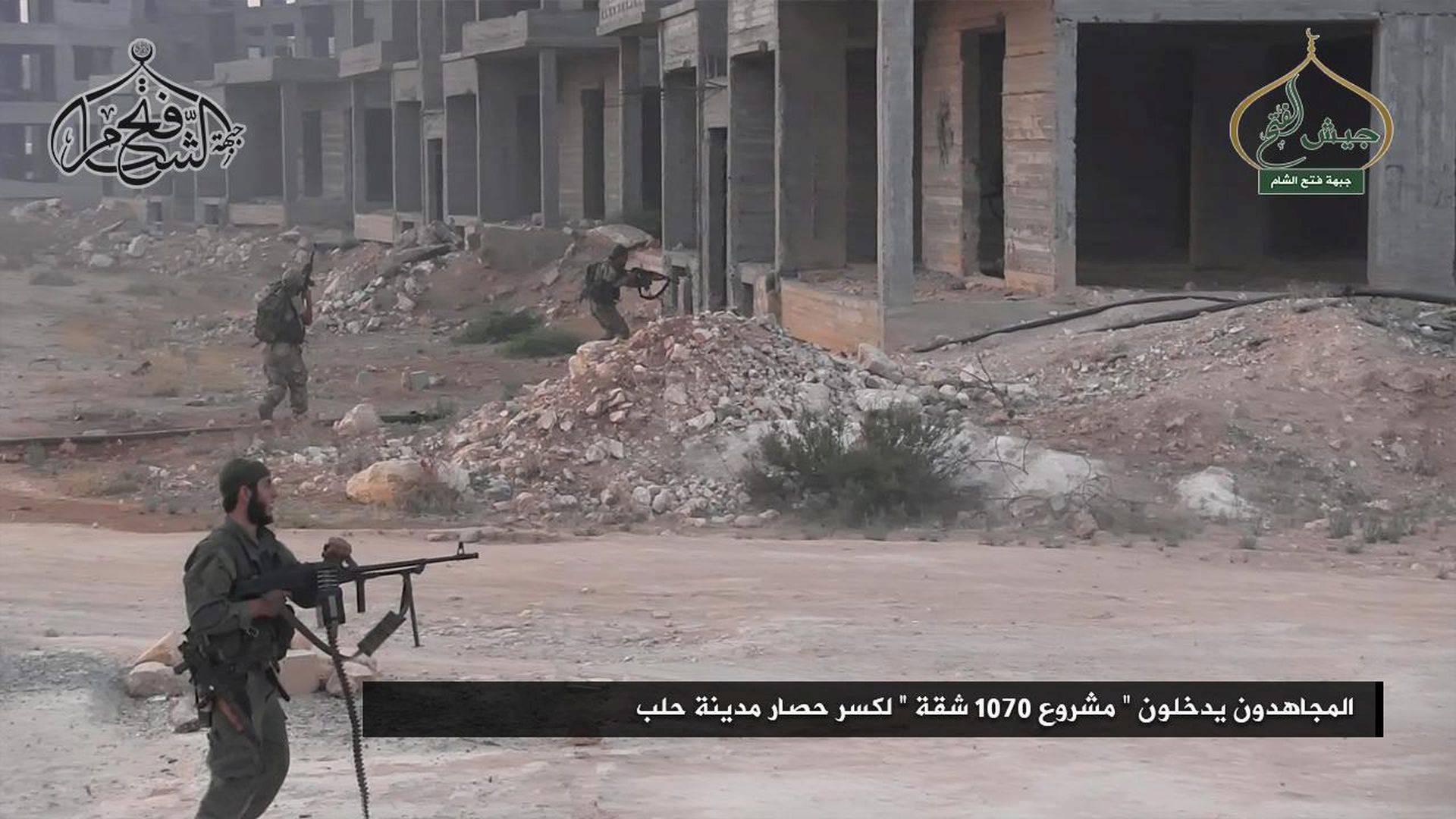 epa05450884 A handout picture made available from Fateh al-Sham front media outlets shows Fateh al-Sham fighters during a battle in Aleppo, Syria, 01 August 2016. According to Fateh al-Sham reports number of surrounding hills in southern Aleppo have been captured by their forces from the Syrian army's hold. The arabic text reads 'Fighters enters the 1070 apartments project during the battle of Aleppo'.  EPA/FATEH AL-SHAM HANDOUT  HANDOUT EDITORIAL USE ONLY/NO SALES