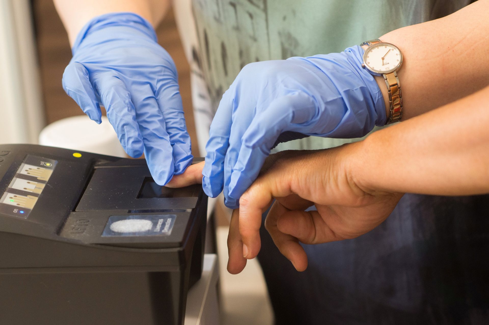 epa05443494 A woman that fled from the Russian federation has her fingerprints scanned in the registration and identification room at the Central Aliens Department of Brandenburg (ZABH) in Eisenhuettenstadt, Germany, 27 July 2016. The new arrival centre of the federal department for migration and refugees (BAMF) and the Brandenburgian ministry of the interior, which is located on the grounds, was officially opened today.  EPA/KLAUS-DIETMAR GABBERT