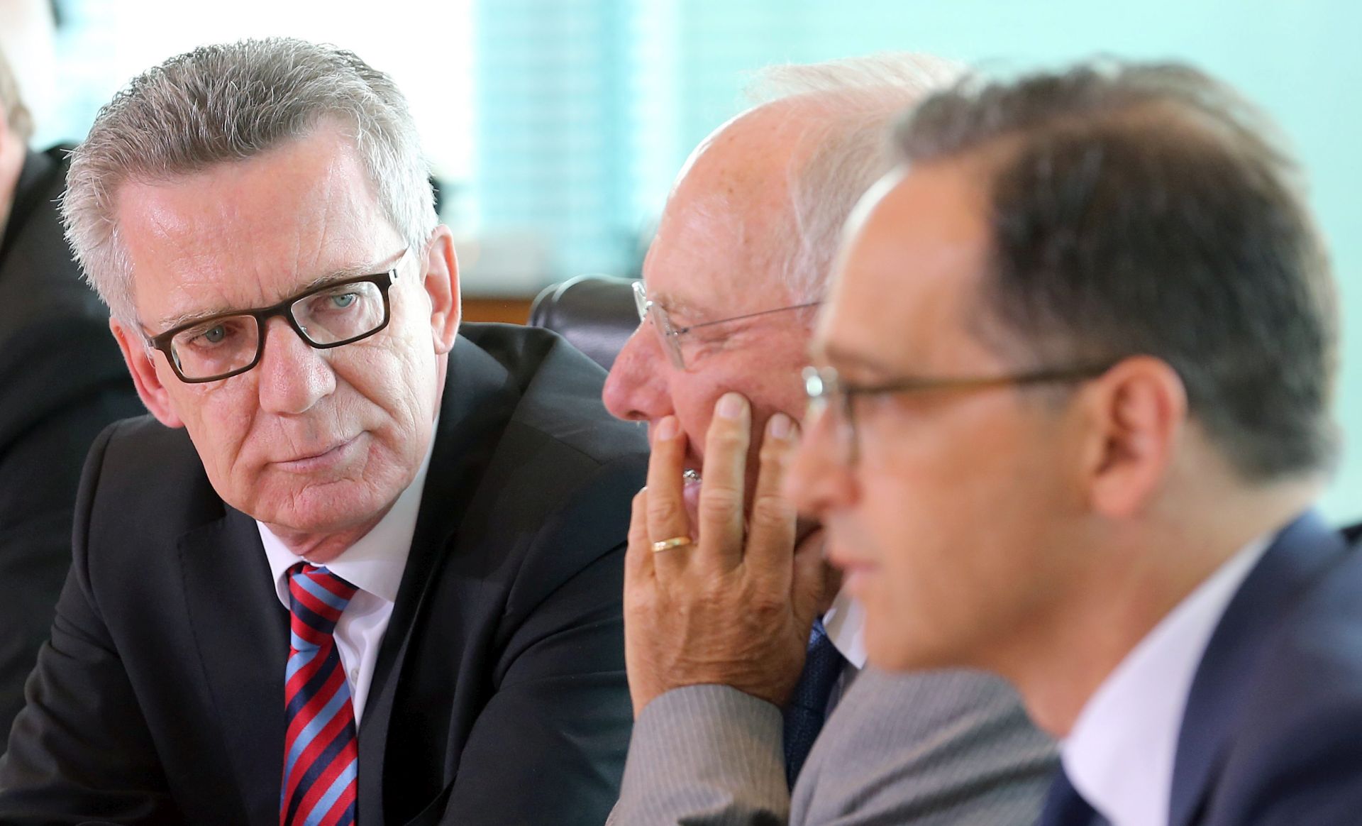 epa05508314 Germany's Interior Minister Thomas de Maiziere (L) sits next to Finance Minister Wolfgang Schaeuble (C) and Justice Minister Heiko Maas (R) at the start of the weekly cabinet meeting in Berlin, Germany, 24 August 2016. Media reports state that the German government ministers are expected to mainly discuss a controversial Civil Defence concept for emergency situations such as terrorist or cyber attacks.  EPA/WOLFGANG KUMM