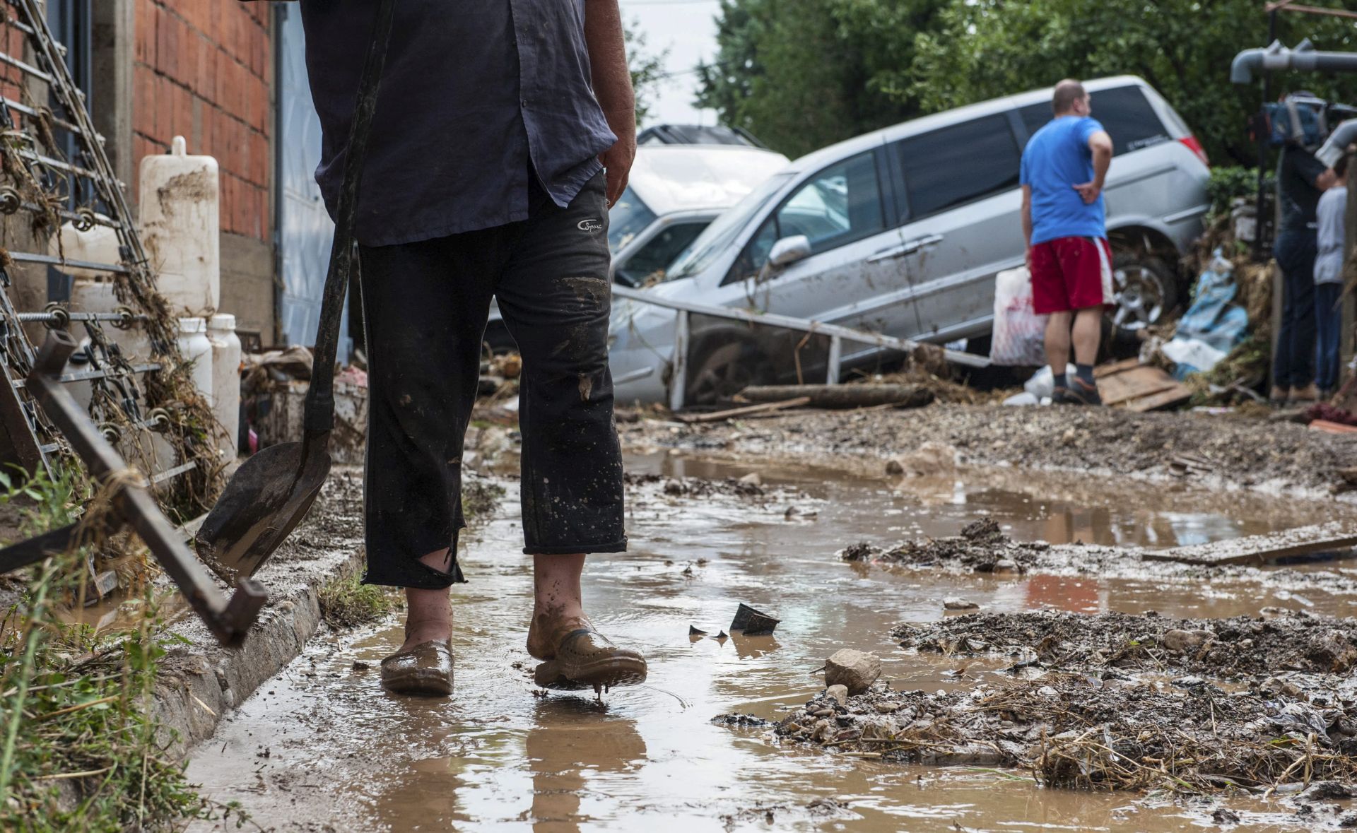 epa05461051 A man stands in mud in front of his flood hit house in the village of Stajkovci, Skopje, The Former Yugoslav Republic of Macedonia on 07 August 2016. At least 15 people have died in a rain storm that hit the Macedonian capital Skopje late on 06 August 2016 causing severe damage to roads, houses and infrastructure. Around 80 vehicles were caught in landslides the hit Skopje's ringroad which remains closed.  EPA/GEORGI LICOVSKI