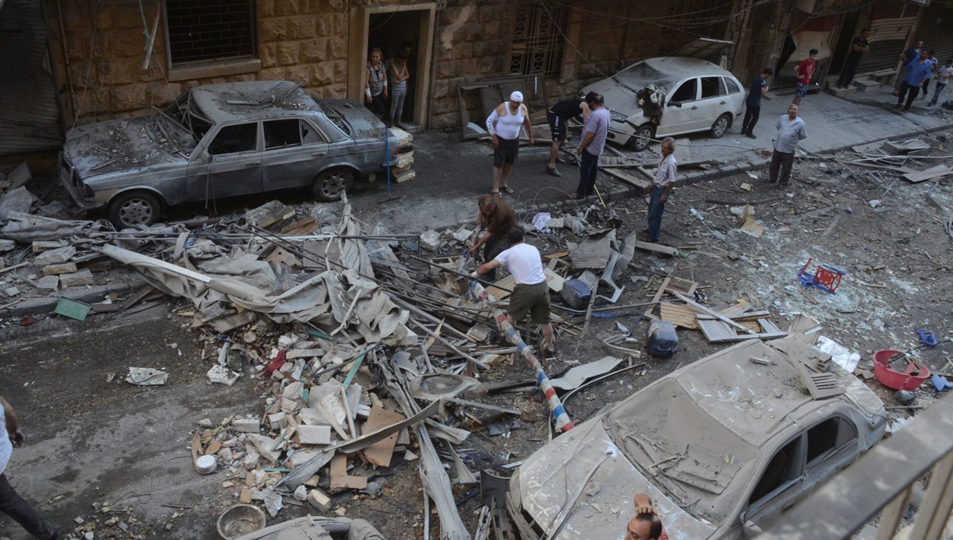 epa05420791 A handout photograph released by the official Syrian Arab News Agency (SANA) shows people inspecting a residential neighborhood after rocket shells attack, in the government-held area of Aleppo, Syria, 11 July 2016. According to SANA, eight people were killed after rocket shells allegedly fired by rebels hit residential neighborhoods in Aleppo.  EPA/SANA HANDOUT  HANDOUT EDITORIAL USE ONLY/NO SALES
