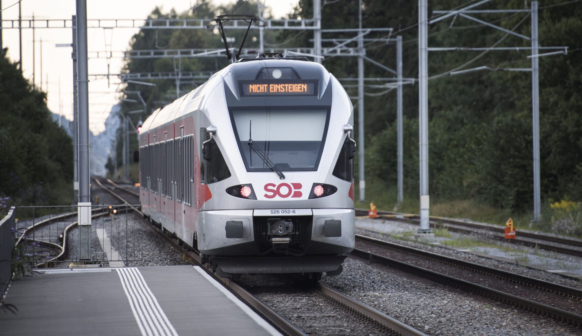 epa05480974 The train stands at the station following an attack onboard, in Salez, Switzerland, 13 August 2016. According to St. Gallen Canton Police Department, a 27 year old man dispersed flammable liquid on the train and set it alight during an attack on the train. He was also armed with at least one knife. Seven people were  injured in the attack.  EPA/GIAN EHRENZELLER