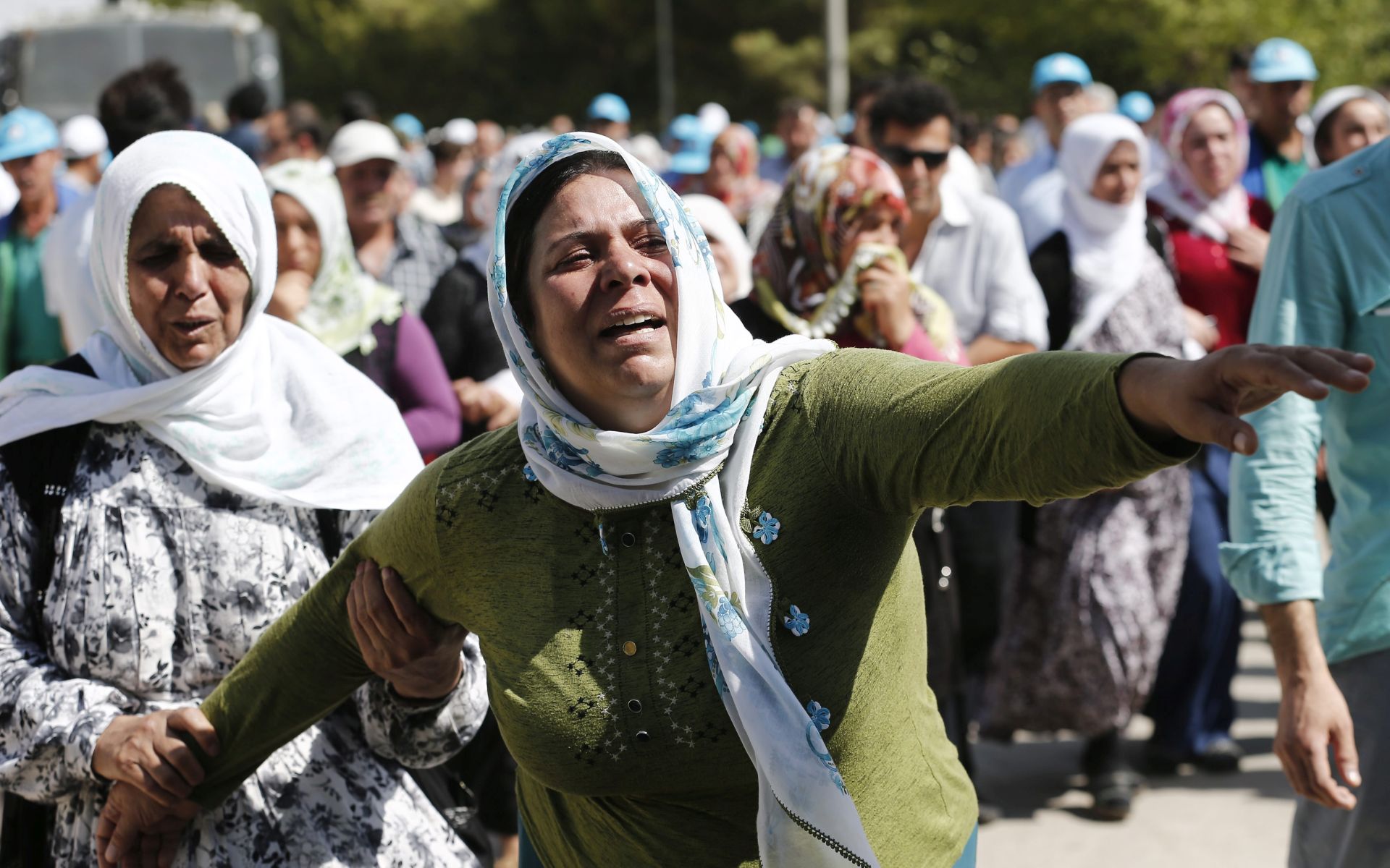 epa05506813 A relatives of Kumri Ilter, who was killed in a bomb attack on late 20 August, is overcome by emotions after a funeral ceremony in Gaziantep, in the southeast of Turkey, 22 August 2016. At least 54 people were killed in a suicide attack late 20 August night during a henna night (a ceremony at the day before wedding) at a street in the Sahinbey district of Gaziantep city. More than half of the people killed in the attack on a Kurdish wedding were children, Turkish officials indicated 22 August.  EPA/SEDAT SUNA