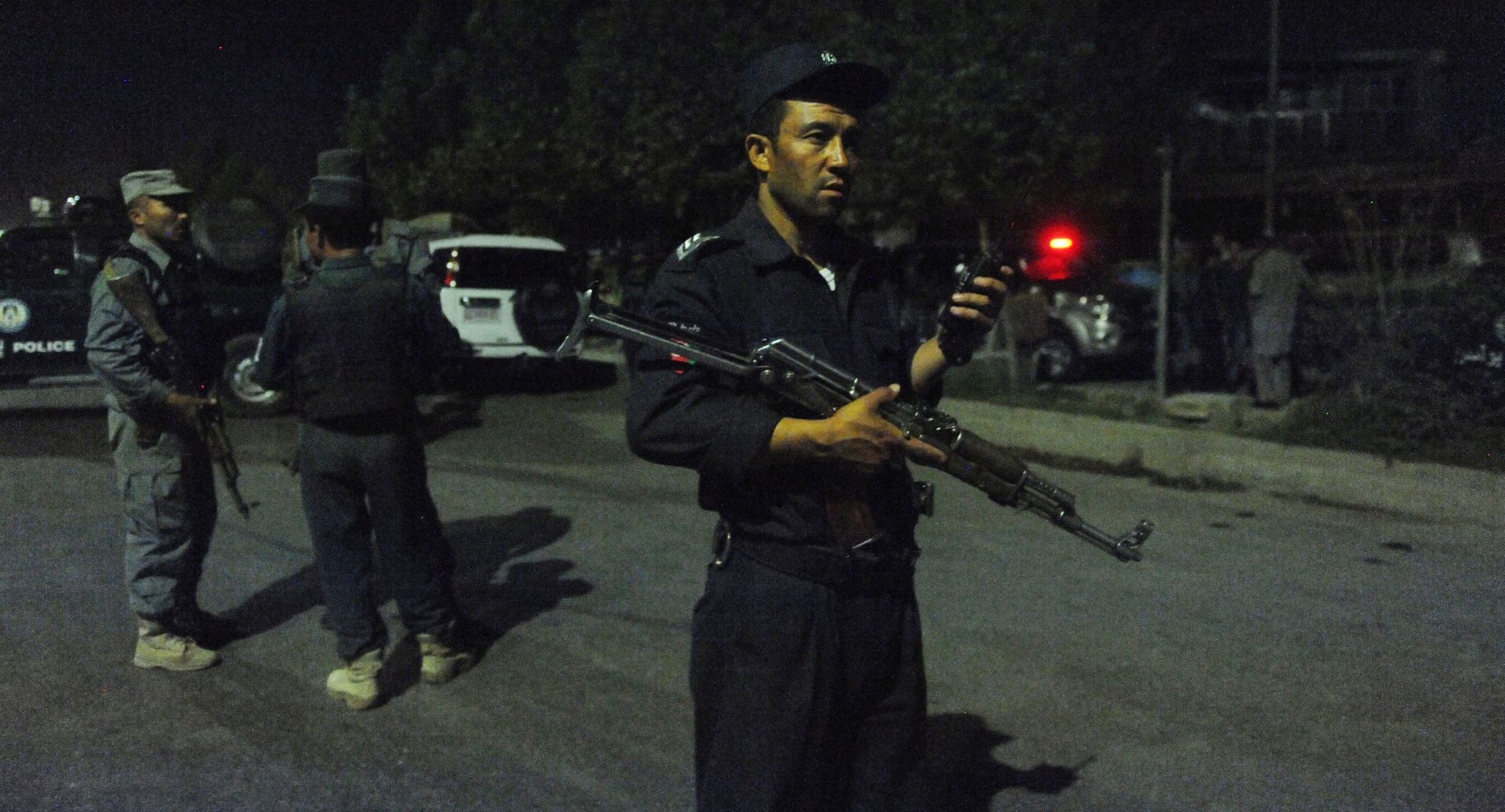 epa05508979 Afghan security officials secure the road leading to the American University of Afghanistan after a Taliban attack on the University in Kabul, Afghanistan, 24 August 2016. According to media reports, one person was killed and 14 injured when Taliban insurgents attacked the University.  EPA/HEDAYATULLAH AMID