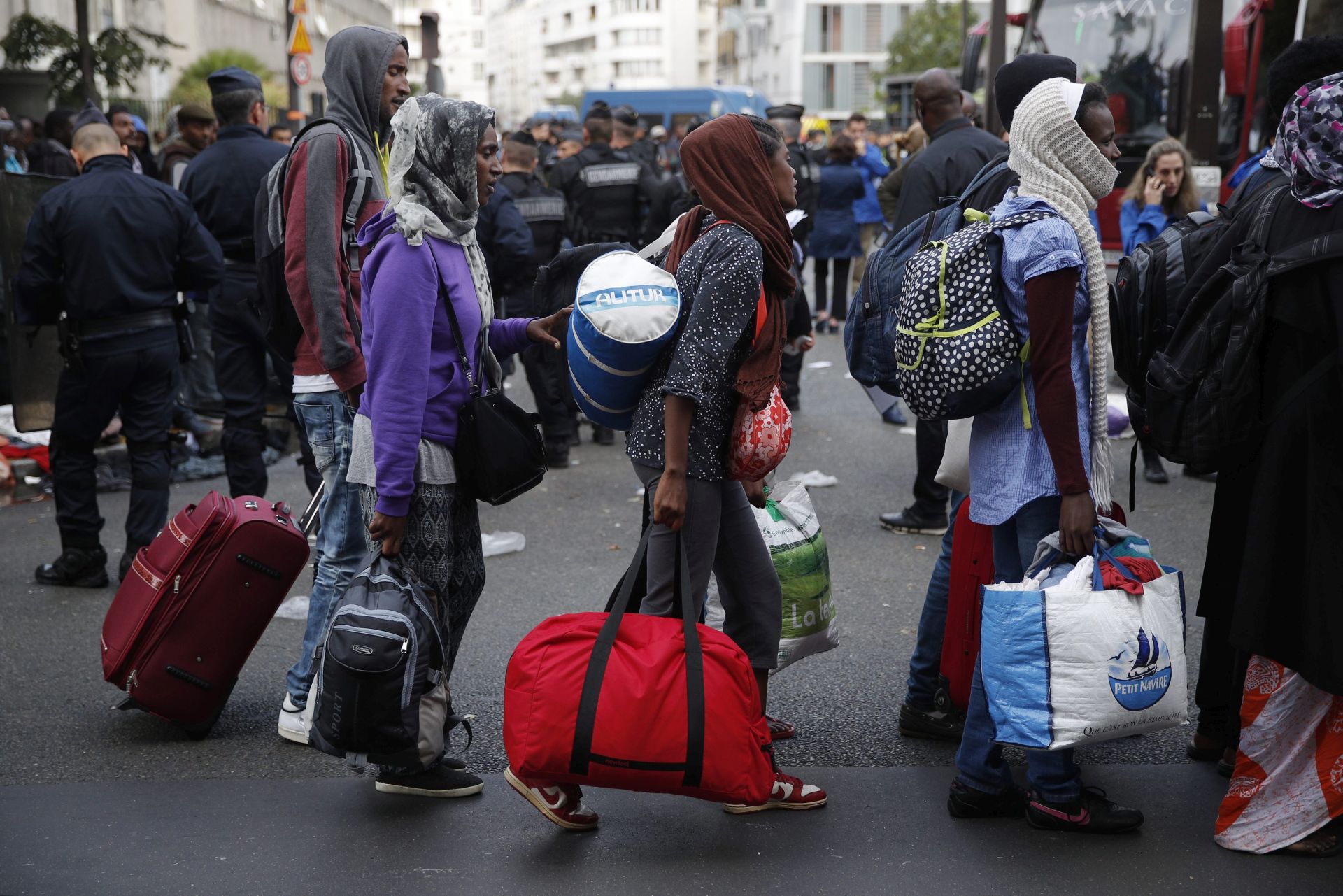 epa05541960 Migrants are evacuated by French riot police from a temporary makeshift camp at the 'Avenue de Flandre' in the North of Paris, France, 16 September 2016. The migrants' situation is reported to be still problematic, noticeably in Paris, as thousands of migrants are on their way to Calais from where they hope to enter Britain. Many of them return from Calais to Paris and settle in the French capital in temporary makeshift camps.  EPA/YOAN VALAT