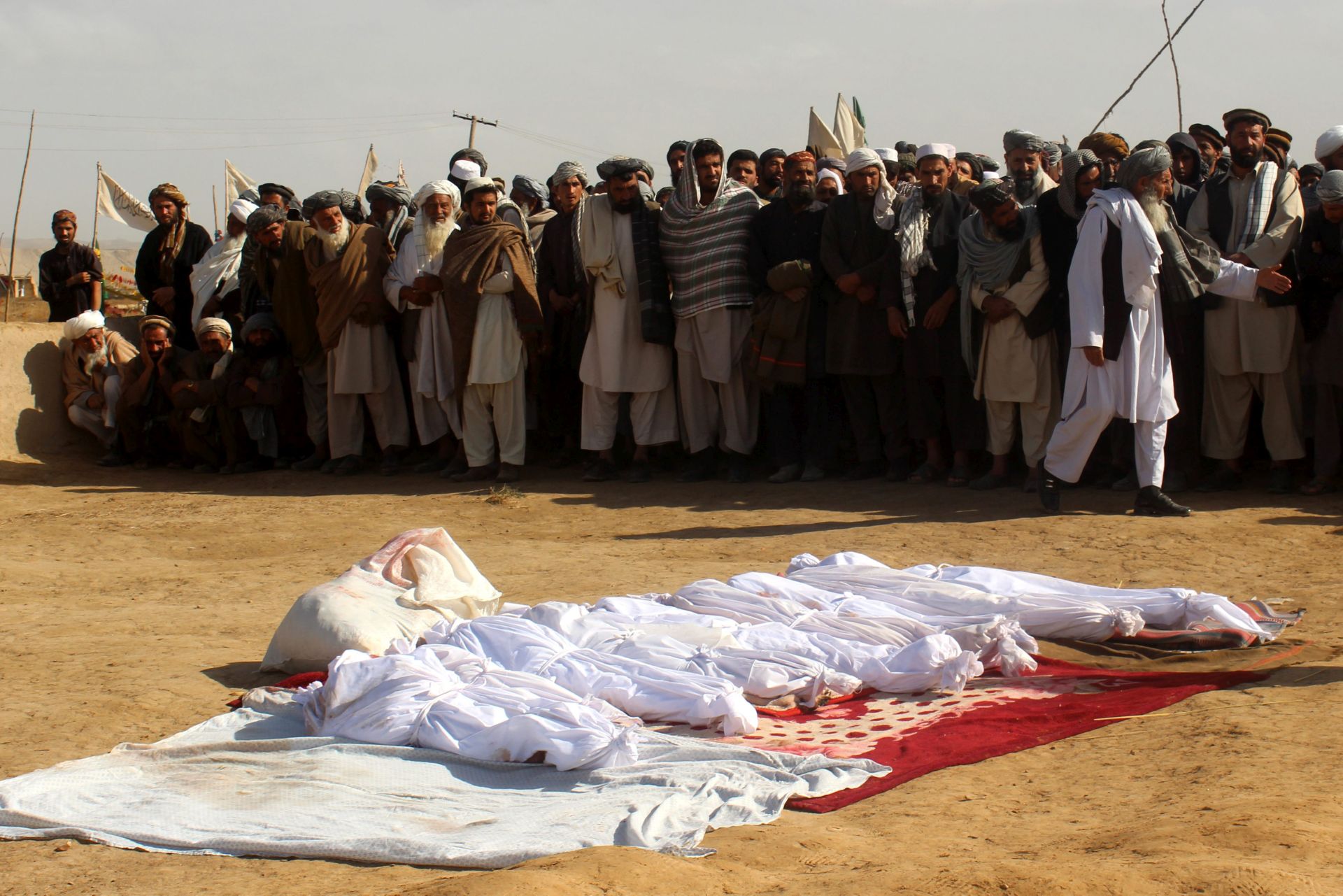 epa05617409 Relatives attend the funeral of Afghan children who were killed in NATO airstrikes in Kunduz, Afghanistan, 04 November 2016. According to media reports, at least 30 Afghan civilians, including women and children, were killed in an alleged NATO airstrikes targeting Taliban militants in support of US and Afghan ground forces.  EPA/NAJIM RAHIM ATTENTION EDITORS : PICTURE CONTAINS GRAPHIC CONTENT