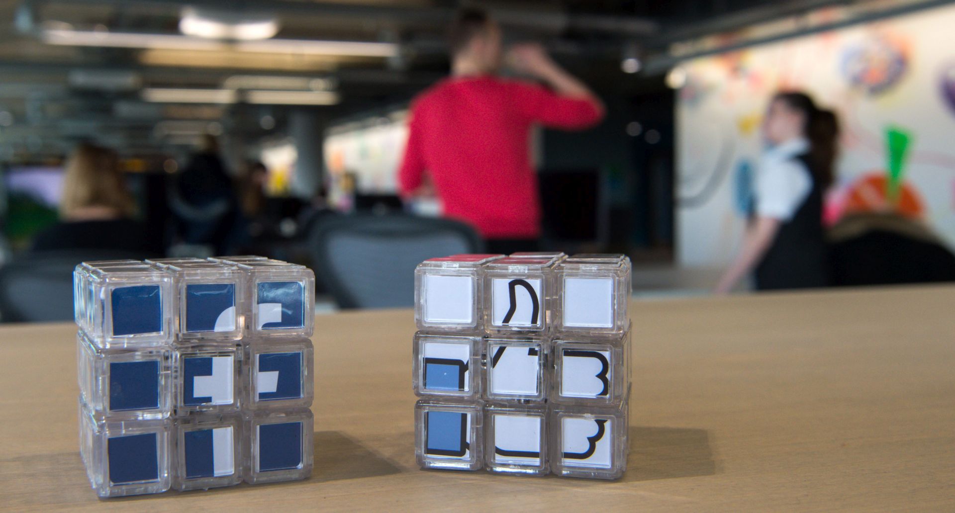 epa05166321 Two magic cubes featuring the logo of 'Facebook' (L) and Facbook's like symbole 'Thumbs up', are seen on a table in the new office of 'Facebook Deutschland' at the Potsdamer Platz in Berlin, Germany, 17 February 2016. The new office of US social network company Facebook will be officially opened on 18 March 2016.  EPA/BERND VON JUTRCZENKA