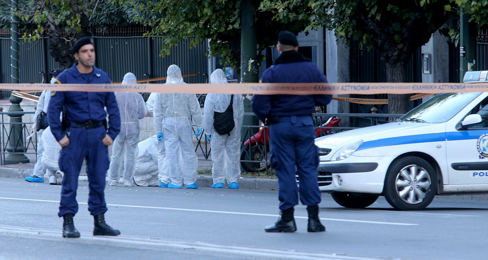 epa05624978 Police investigators examine the area outside the French embassy in Athens, Greece, 10 November 2016. According to reports, a grenade was thrown at the guard's post injuring a police officer who was on duty.  EPA/PANTELIS SAITAS