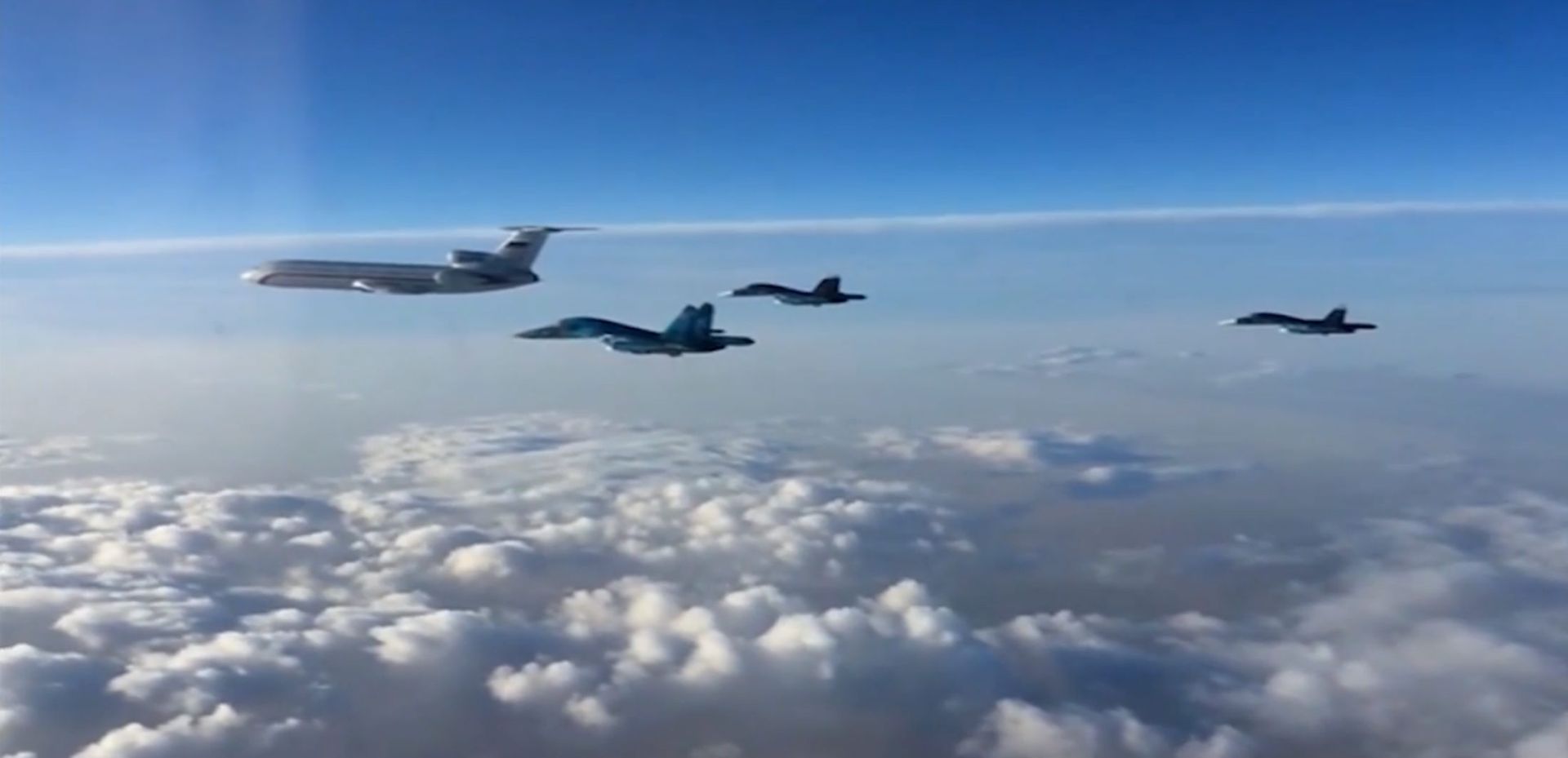 epa05212422 A handout frame grab taken from a video footage made available 15 March 2016 by the Russian Defence Ministry shows Russian TU-154 plane which transports engineering and technical personnel in the head of a group of Russian SU-34 multidimensional bombers in flight from the Syrian Hmeymim airbase outside Latakia to Russia.  First group of Russian warplanes left the Hmeymim airbase for permanent location airfields in Russia. Russian President Vladimir Putin ordered the withdrawal of the majority of Russian troops from Syria on March 15.  c