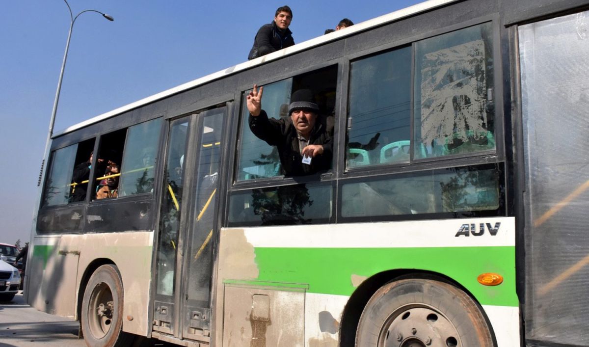 epa05682575 A handout photograph released by the official Syrian Arab News Agency (SANA) showing a Syrian man,  who was among the evacuees from Kafarya and Fuah villages of Idlib province, flashing the victory sign upon arriving at a temporary housing center in Jebrin, Aleppo countryside, Syria, 19 December 2016. According to SANA, more than 500 of wounded people and patients from Kafarya and Fuah villages in the northern countryside of Idlib have arrived a temporary housing center in Jebrin in Aleppo countryside. The evacuation from the Shiite towns besieged by rebels is part of the same deal by which people have left government-besieged areas in the northern Syrian city of Aleppo.  EPA/SANA HANDOUT  HANDOUT EDITORIAL USE ONLY/NO SALES
