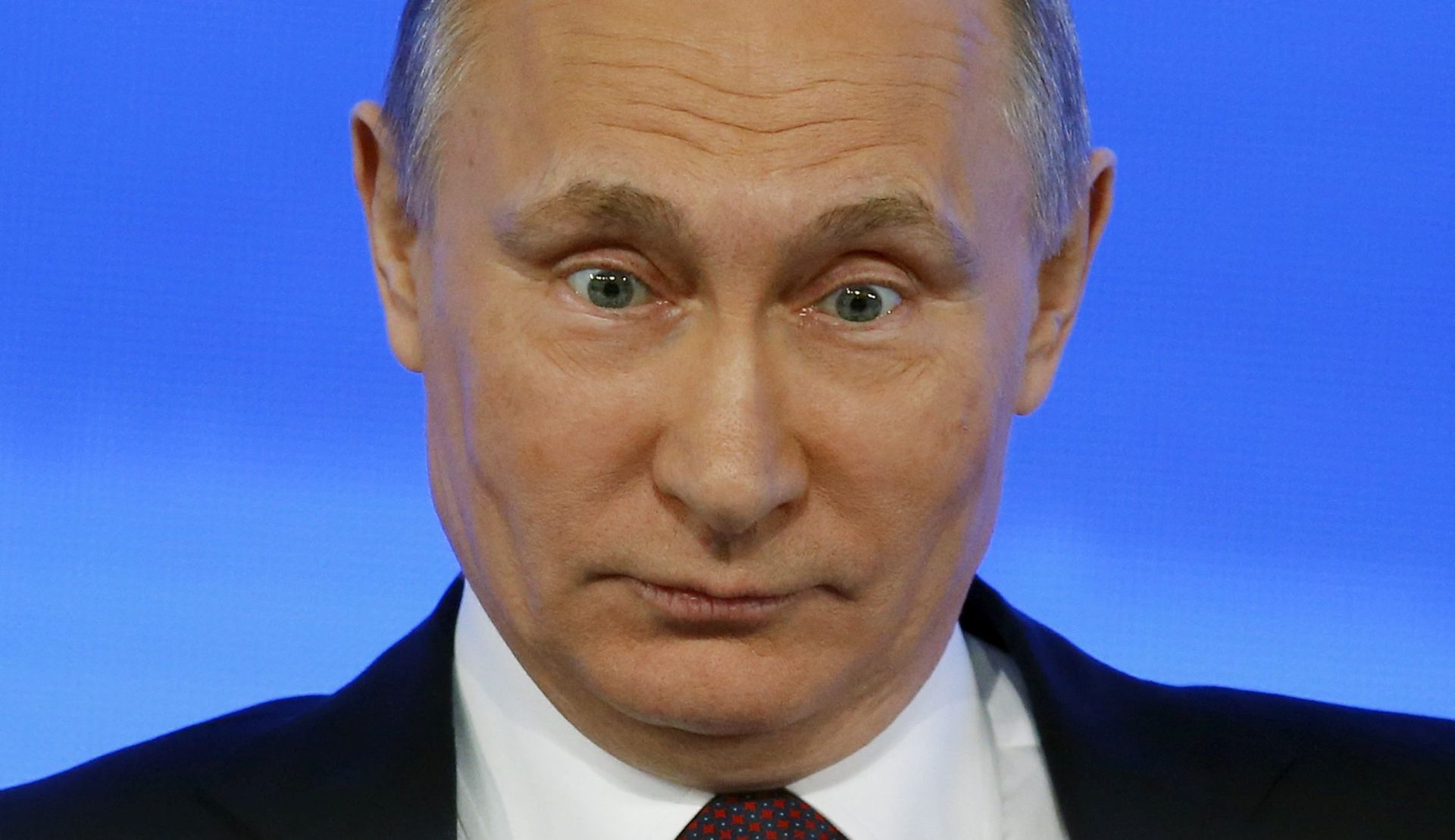 epa05686343 Russian President Vladimir Putin reacts to a question during his annual media conference at the International Trade Center in Moscow, Russia, 23 December 2016.  A totalof 1,437 journalist from all regions of Russia are accredited at the press conference with many of them using various creative ways to attract the attention of the Russian leader and to ask their questions.  EPA/YURI KOCHETKOV