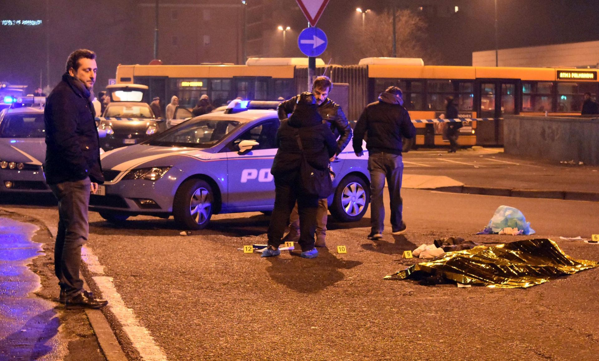 epa05686384 Italian police stand around a body after a shootout between police and a man in Milan's Sesto San Giovanni neighborhood, early 23 December 2016. Italy's Interior Minister Marco Minitti meanwhile has confirmed that the identity of the individual shot dead after a gunfight with Italian police this morning near Milan is Anis Amri, the 24 year old Tunisian suspected of the 19 December Berlin Christmas Market terrorist truck attack, that left at least 12 people dead and around 50 others injured.  EPA/DANIELE BENNATI
