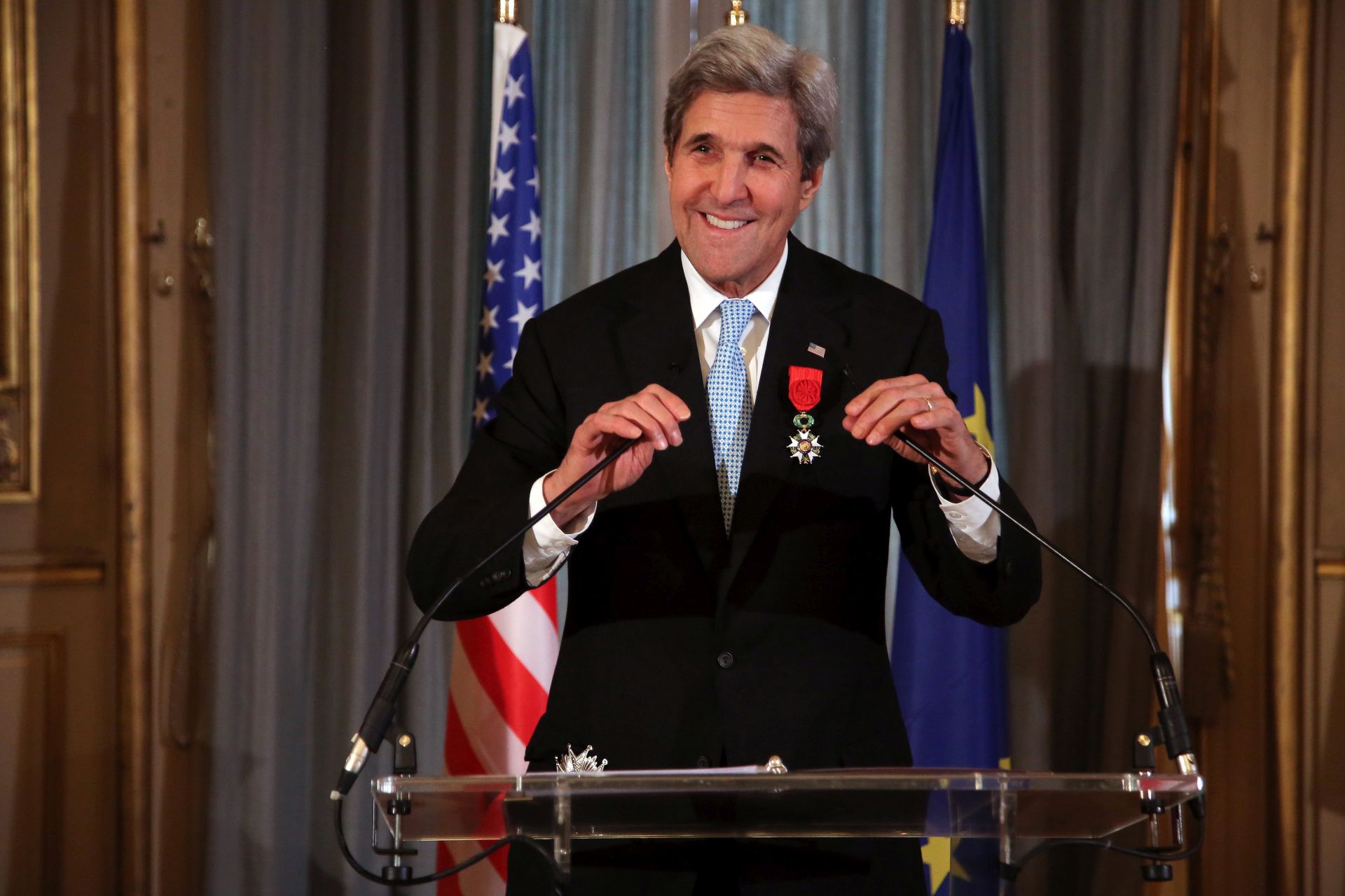 epa05670511 A photograph made available on 11 December 2016 showing US Secretary of State John Kerry smiles before delivering a speech after being awarded of the Legion d'Honneur medal, at the Quai d'Orsay foreign affairs ministry, in Paris, France, 10 December 2016. The Foreign Ministry said he earned the distinction 'for his contribution of the development of relations between France and the United States, and his indefatigable efforts in favor of peace in the world.'  EPA/THIBAULT CAMUS/POOL MAXPPP OUT