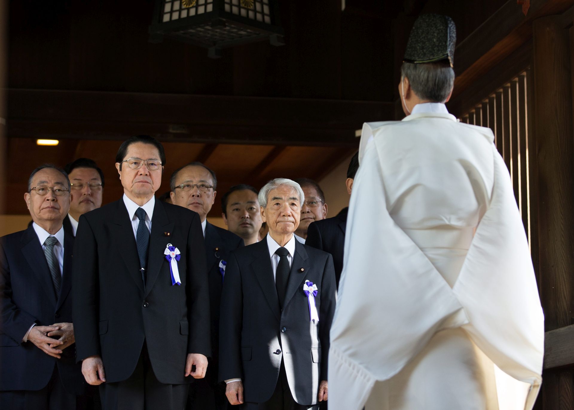 epa05271348 A 'Kannushi' or Shinto priest (R) prepares to lead a group of Japanese lawmakers including former Secretary-General of Japan's Defense Agency Seishiro Eto (2-L) and former Minister of Health, Labour, and Welfare of Japan Hidehisa Otsuji (2-R), to pay their respects to the war dead at Yasukuni Shrine in Tokyo, Japan, 22 April 2016. Lawmakers visit the shrine during the annual spring festival. Over 2.5 million Japanese soldiers who died in the service are enshrined at Yasukuni, some which include convicted war criminals from World War II.  EPA/CHRISTOPHER JUE