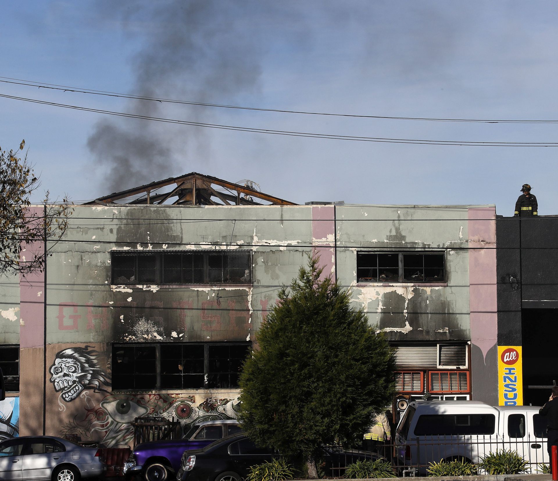 epa05658550 Firefighters work at the aftermath of  a warehouse fire in the Fruitvale district of Oakland at the corner of 31st. Avenue and International Boulevard in Oakland, California, USA, 03 December 2016. Reports indicate that a musical performance was going on with a crowd inside the warehouse. Nine people are already confirmed dead and more than a dozen more are still missing.  EPA/JOHN G. MABANGLO