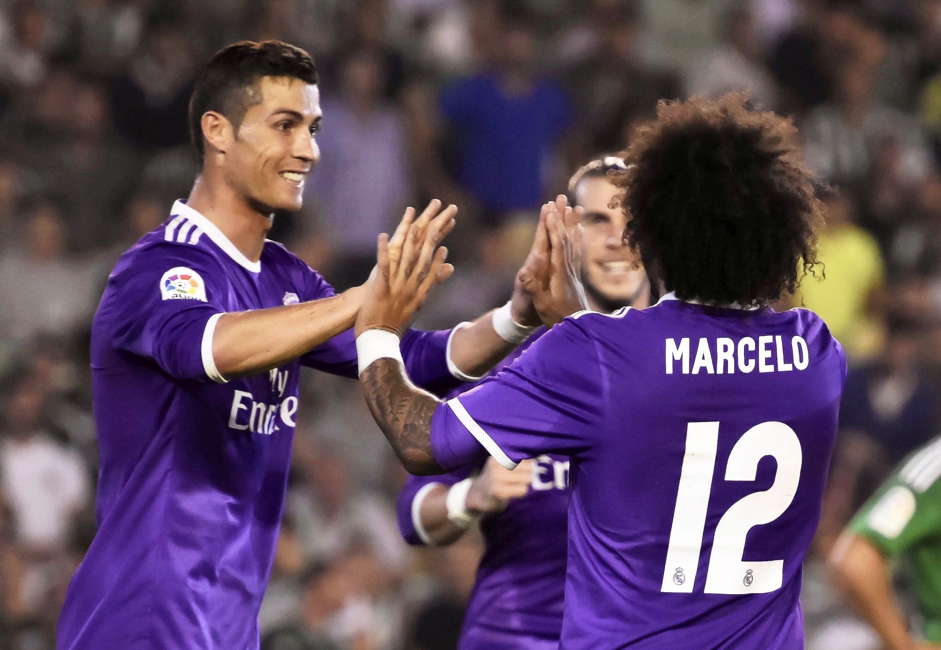 epa05587109 Real Madrid's Brazilian defender Marcelo (R) celebrates with his Portuguese  teammate Cristiano Ronaldo (R) after scoring the 3-0 lead during the Spanish Primera Division soccer match betweeen Real Betis and Real Madrid  at Benito Villamarin Stadium in Seville, Spain, 15 October 2016.  EPA/RAUL CARO