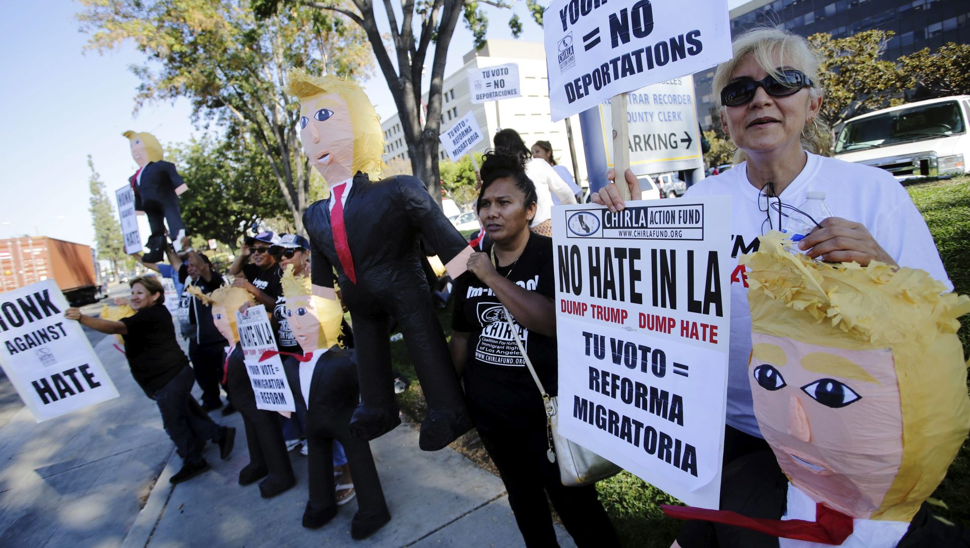 epa05517738 Anti-Trump demonstrators hold Donald Trump pinatas as they hold a protest outside the County Registrar's Office in  Norwalk, California, USA, 31 August 2016. Donald Trump, the Republican residential nominee, visited Mexico and met with Mexican President Enrique Pena Nieto is due to make a speech on immigration. Trump has made numerous controversial remarks about Mexican immigrants during his campaign rallies, and has stated his intention to build a wall on the border between the United States and Mexico in order to prohibit potential undocumented immigrants from coming into the United States.  EPA/MIKE NELSON