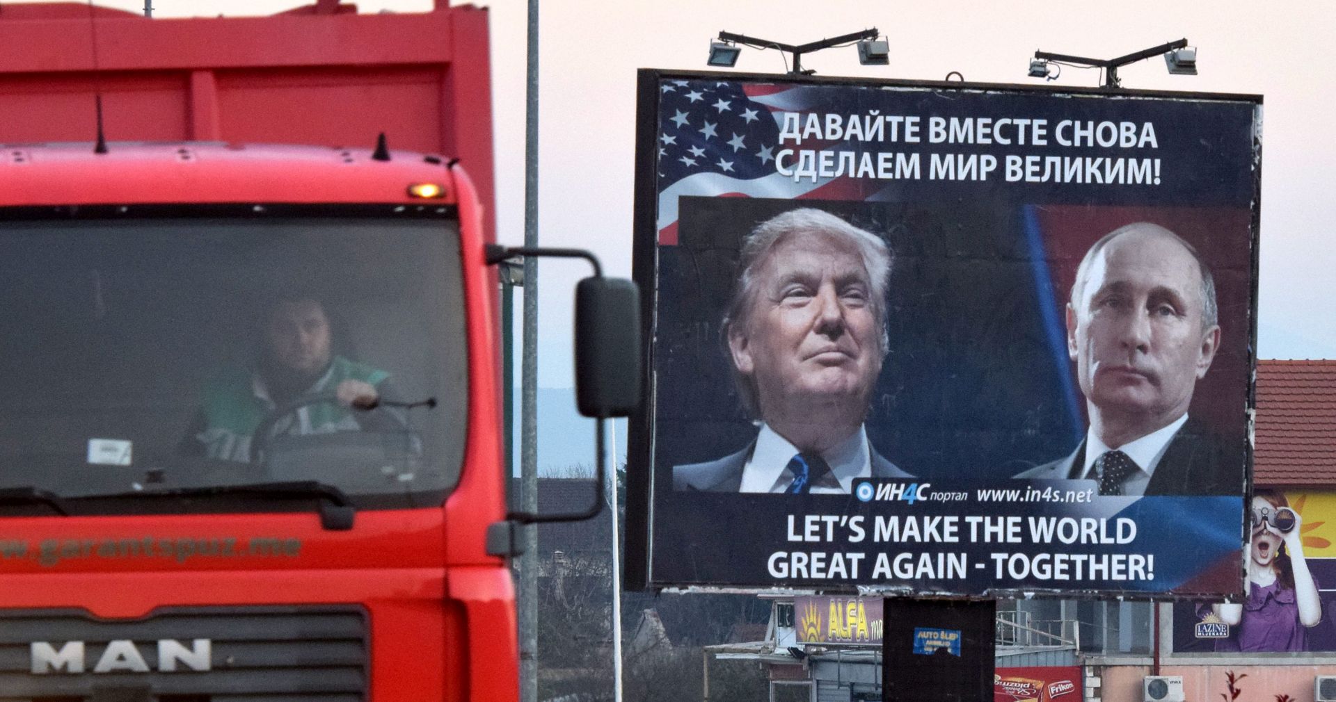 epa05634154 A billboard by pro-Serbian movement shows the image US President-elect Donald Trump and Russian President Vladimir Putin as a truck drives past in the town of Danilovgrad, Montenegro, 16 November 2016. Presidents Donald Trump and Vladimir Putin spoke by phone of better relations in the future between Washington and Moscow on 15 November.  EPA/BORIS PEJOVIC