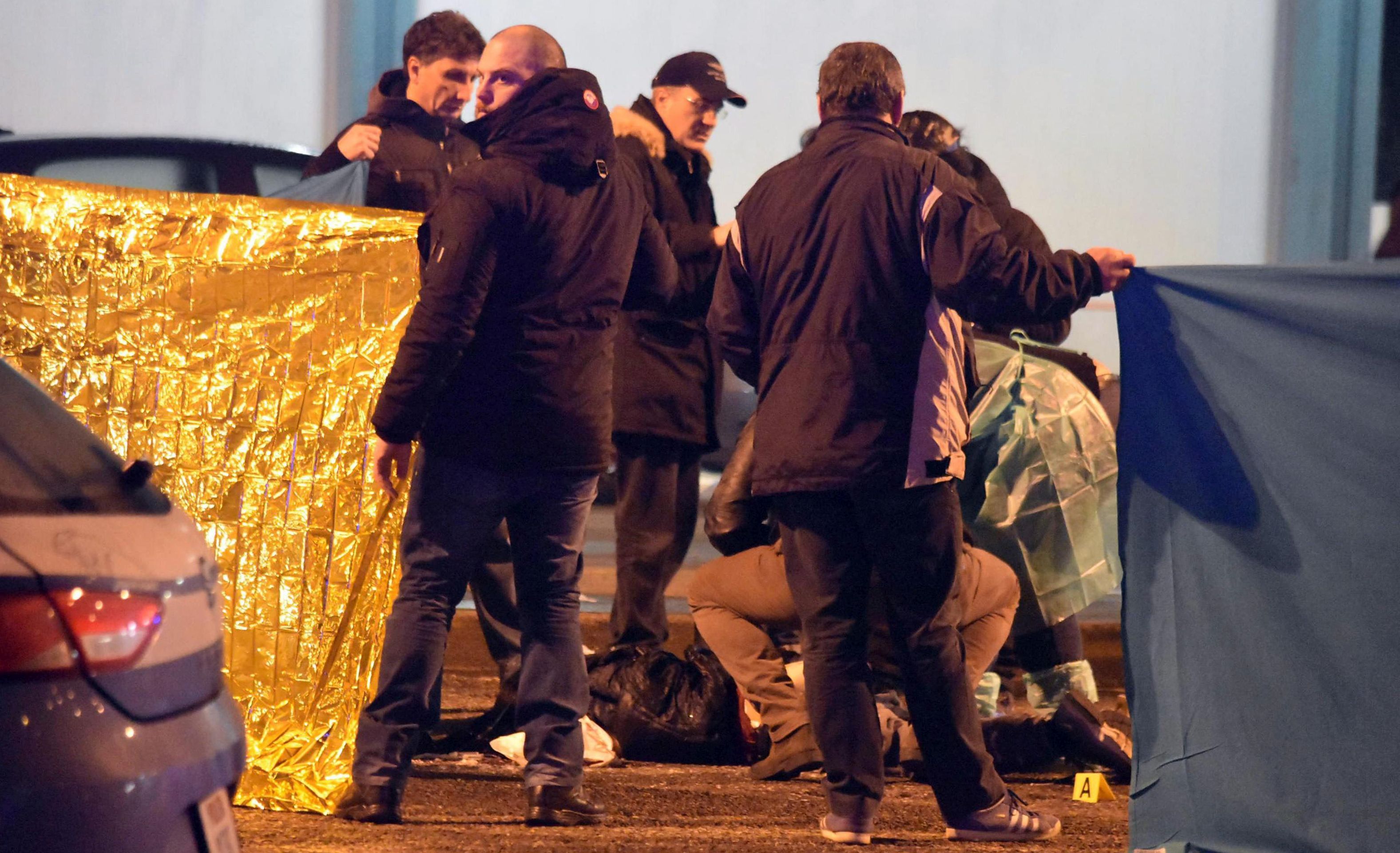 epa05686494 Italian police uses blankets to prevent a direct view at the dead body at the scene of a shootout between police and a man in Milan's Sesto San Giovanni neighborhood, early 23 December 2016. Italy's Interior Minister Marco Minitti meanwhile has confirmed that the identity of the individual shot dead after a gunfight with Italian police this morning near Milan is Anis Amri, the 24 year old Tunisian suspected of the 19 December Berlin Christmas Market terrorist truck attack, that left at least 12 people dead and around 50 others injured.  EPA/DANIELE BENNATI