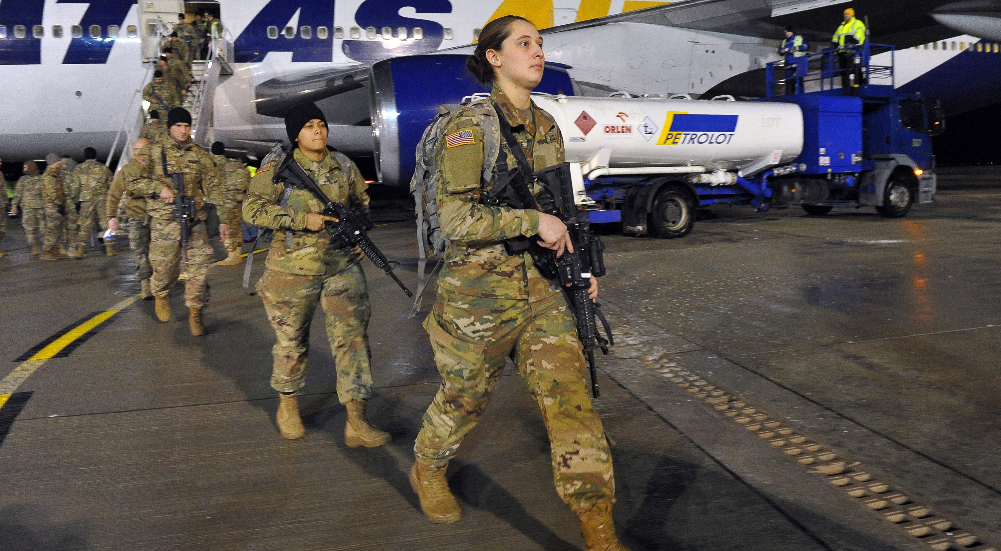 epa05713800 US soldiers arrive at the airport in Goleniow, Poland, 12 January 2017. Some 173 US soldiers arrived to Goleniow as part of an effort to reinforce NATO's eastern flank. The American armoured brigade - the 3rd Armored Brigade Combat Team, part of the 4th Infantry Division, from Fort Carson, Colorado, is to be deployed to Poland as well as the Baltic states and Romania as part of Operation Atlantic Resolve.  EPA/MARCIN BIELECKI POLAND OUT