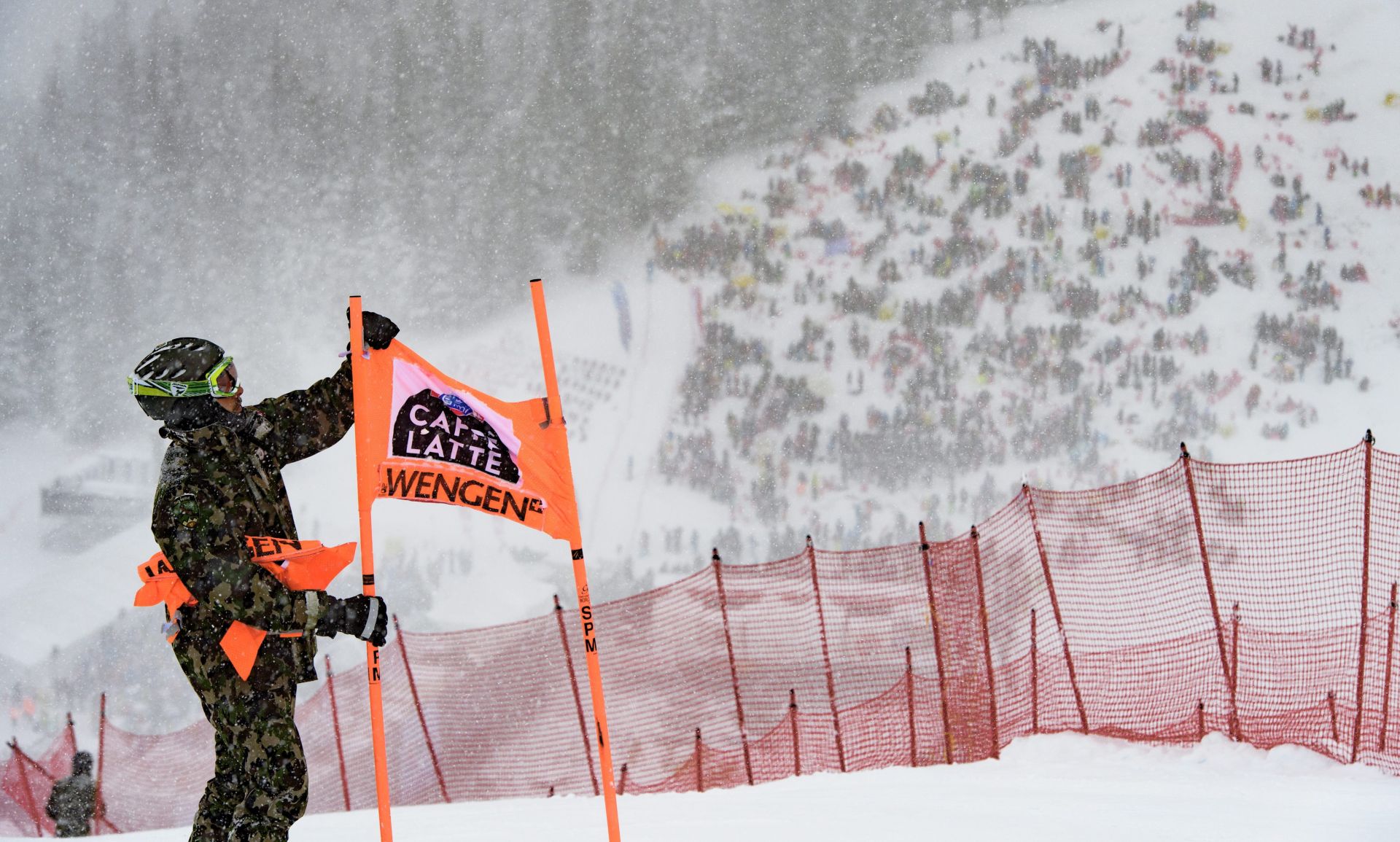 epa05716432 A volunteer takes down a gate of the men's downhill course of the FIS Alpine Ski World Cup at the Lauberhorn, in Wengen, Switzerland, 14 January 2017. The race had to be cancelled due to heavy snowfall.  EPA/JEAN-CHRISTOPHE BOTT