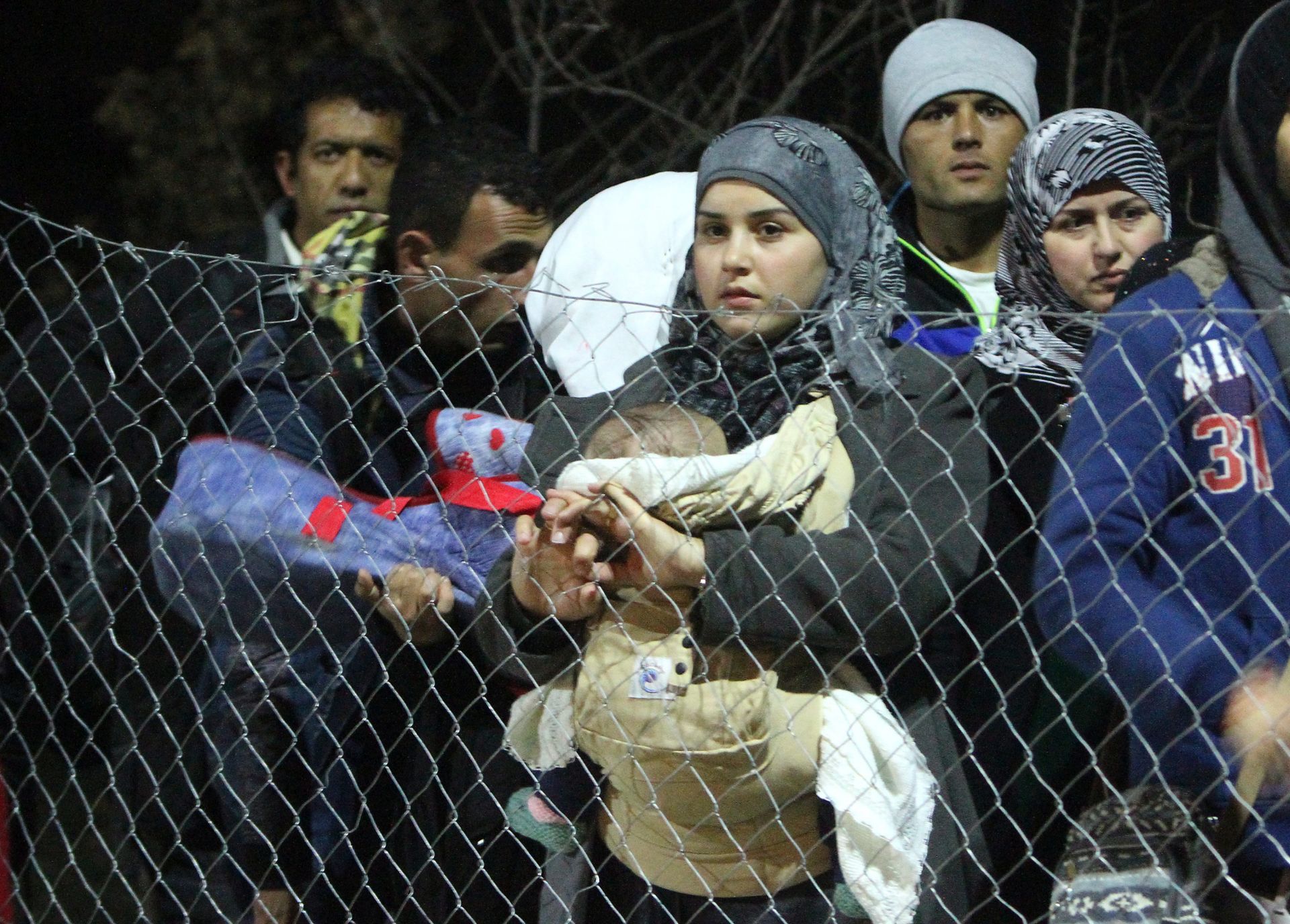 epa05163516 A group of migrants from Syria, Iraq and Afghanistan wait in line to be registered in front of a temporary camp for migrants in the village of Miratovac, on the border between Serbia and Macedonia, close to the south Serbian city of Presevo, Serbia, 15 February 2016.  EPA/DJORDJE SAVIC