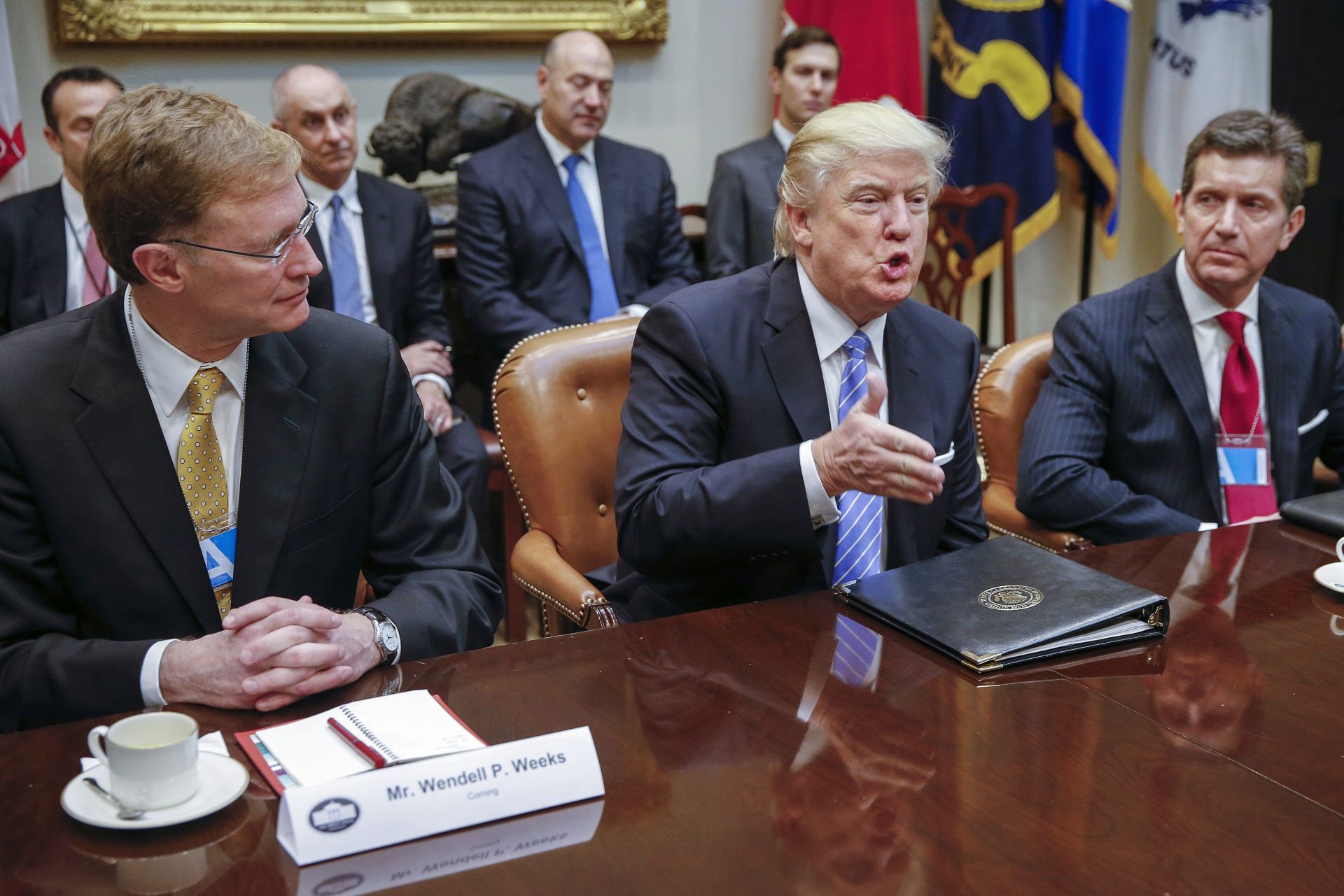 epa05744603 US President Donald J. Trump (C), CEO of Corning Wendell Weeks (L) and CEO of Johnson & Johnson Alex Gorsky (R), attend a meeting with business leaders in the Roosevelt Room of the White House in Washington, DC, USA, 23 January 2017. President Trump was set for a day of meetings with Business leaders, Union leaders, Congressional leaders and meeting with Speaker of the House, Paul Ryan later this afternoon.  EPA/SHAWN THEW