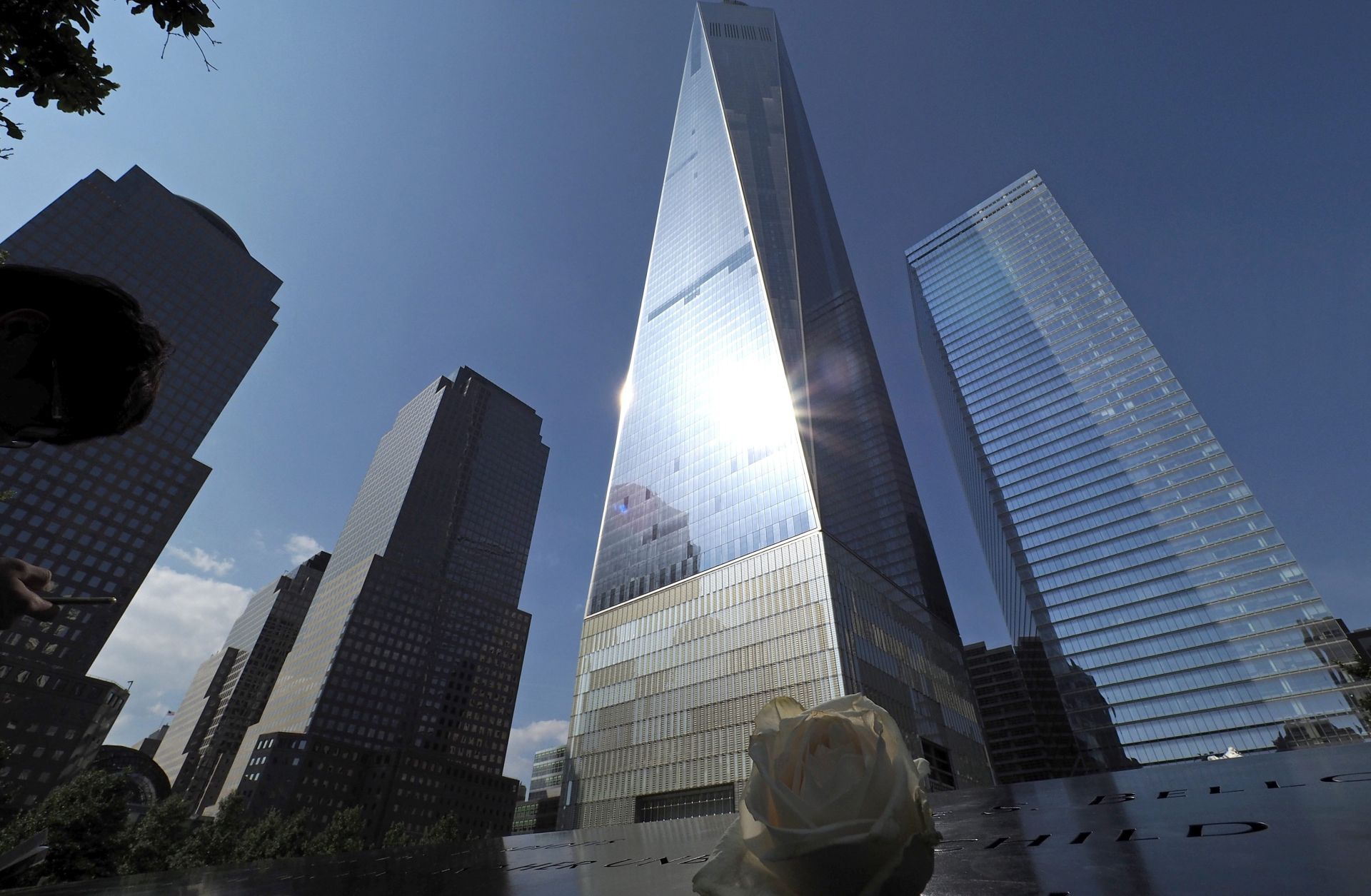epaselect epa04904690 A white rose is laid on the World Trade Center Memorial North Pool wile the new World Trade Center looms in the background in lower Manhattan in New York, New York, USA, 29 August 2015. Upcoming 11 September 2015 will mark the 14th Anniversary of the terrorist attacks on the World Trade Center.  EPA/JOHN G. MABANGLO
