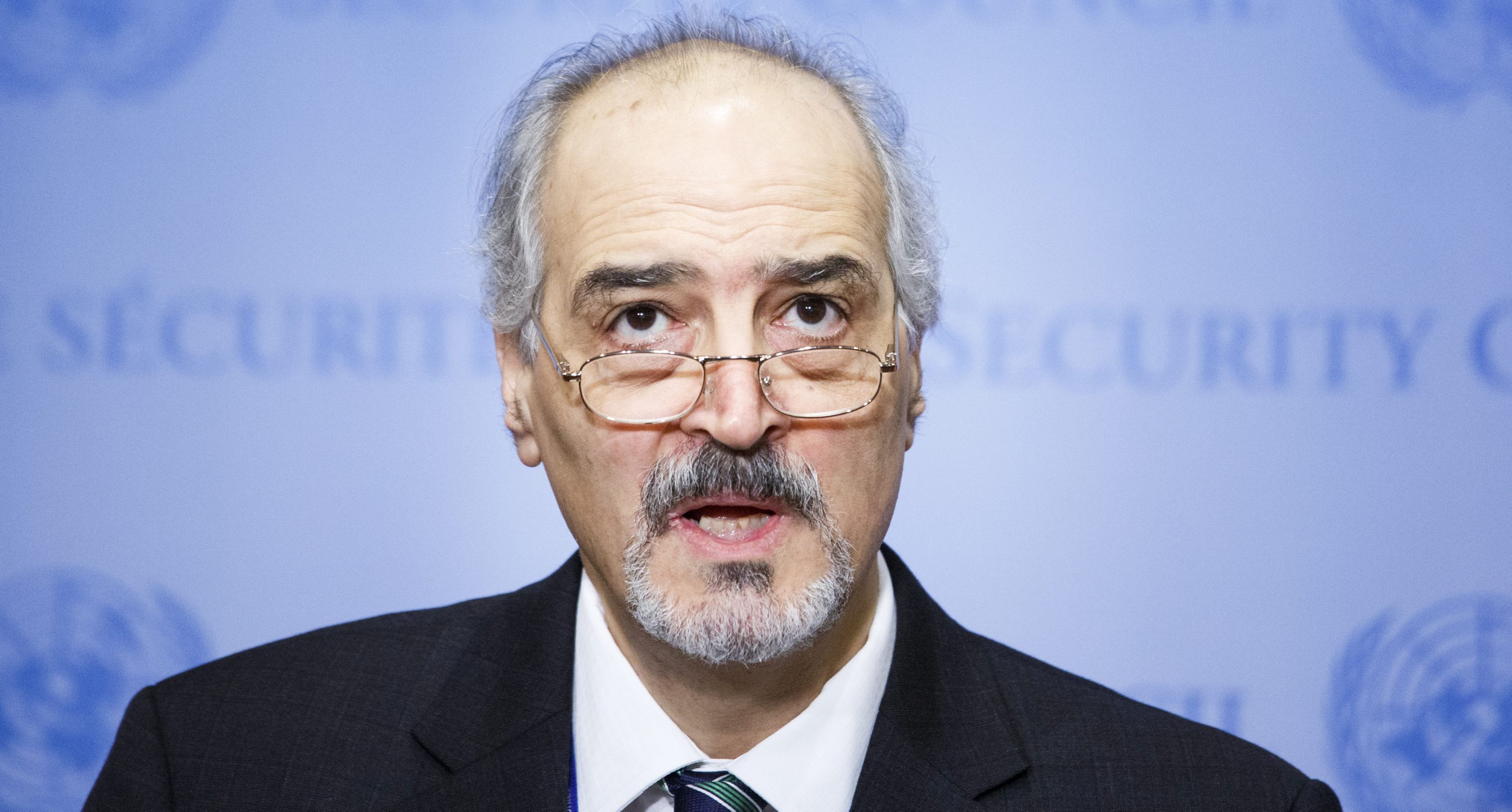 epa05682368 Ambassador Bashar Ja'afari, Syria's Permanent Representative to the United Nations, talks with reporters after the United Nations Security Council voted to approve a resolution to send United Nations observers to witness the evacuation of people from the city of Aleppo, Syria, at United Nations headquarters in New York, New York, USA, 19 December 2016.  EPA/JUSTIN LANE