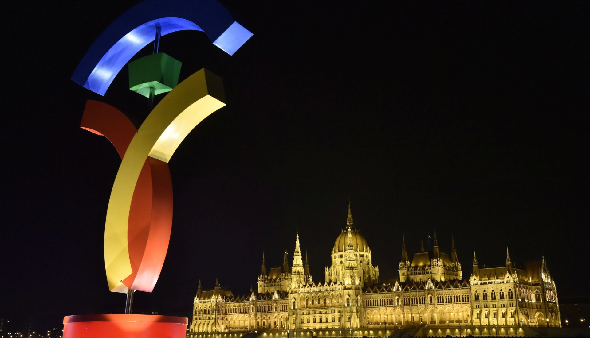 epa05728539 The logo of the host city candidate Budapest for the 2024 Olympic and Paralympic Games is lit on Batthyany square in Budapest, Hungary, 18 January 2017. In the background the building of the Parliament is seen. The Hungarian capital is one of the three candidate cities in bidding to host the 2024 summer games.  EPA/Zoltan Mathe HUNGARY OUT