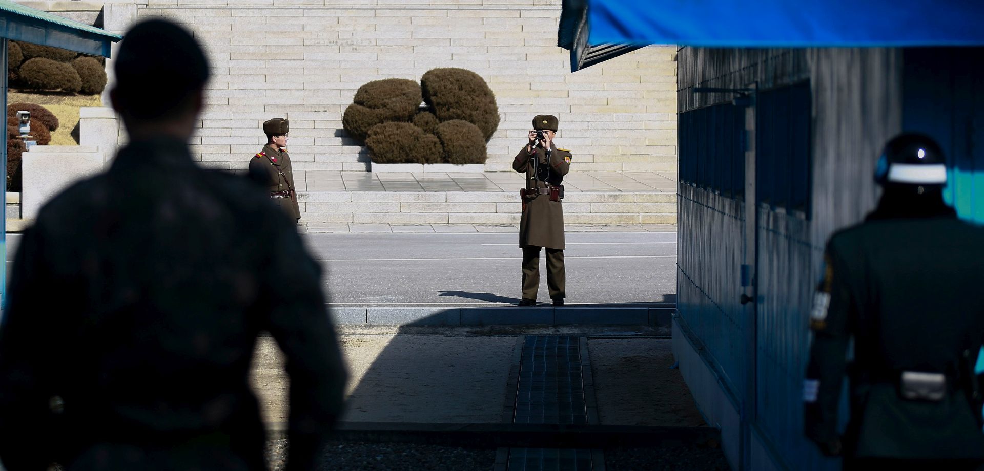 epa05801115 A North Korean soldier (C) takes pictures during the visit of Julie Bishop (not pictured), Australian Minister for Foreign Affairs,at the Military Demarcation Line in the Demilitarized Zone (DMZ) in the border village of Panmunjom, South Korea, 18 February  2017. Julie Bishop is visiting South Korea for talks with officials that will focus on the North Korea nuclear threat.  EPA/KIM HEE-CHUL