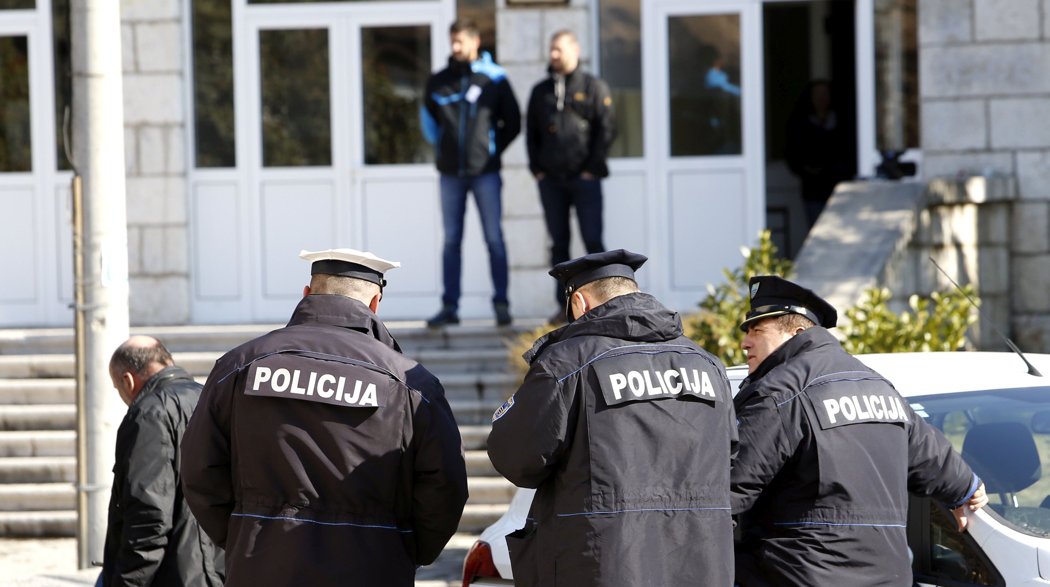 epa05803635 Bosnian police in Stolac in front of a polling station during voting by Bosnian Muslims and Bosnian Croats, who are voting for a second time, repeating elections for local government in Stolac, Bosnia and Herzegovina, 19 February  2017. The Central Election Commission of Bosnia annulled the elections for Stolac which were held on 02 October 2016. The Central Election Commission revealed irregularities, on the voting in Stolac and found 143 names of people who died on the electorial lists.  EPA/FEHIM DEMIR