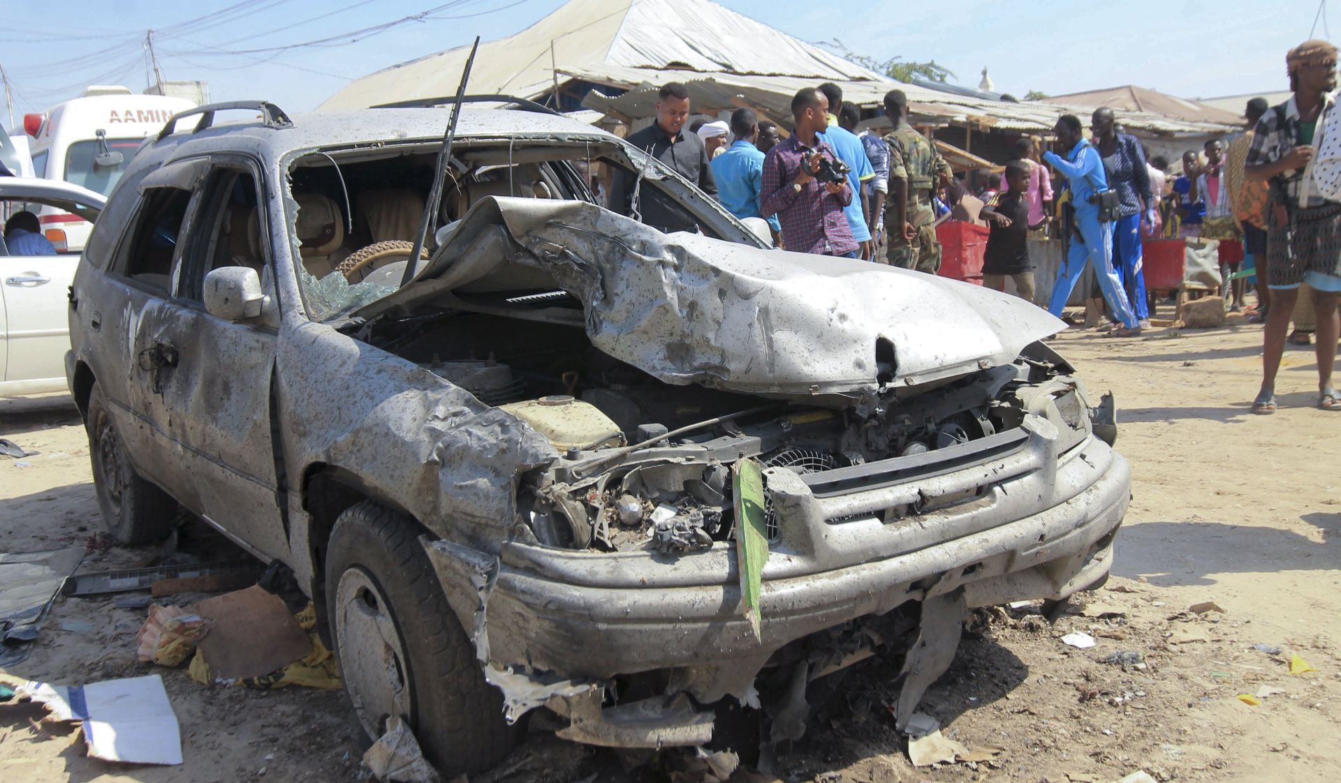 epa05803719 A destroyed car at the scene of an explosion, thought to be caused by a car bomb, in the capital Mogadishu, Somalia, 19 February 2017. Media reported at least 14 people have been killed, quoting local authority. No one has claimed responsibility for the attack but the country's Islamist militant group al-Shabab has carried out similar attacks in the capital.  EPA/SAID YUSUF WARSAME