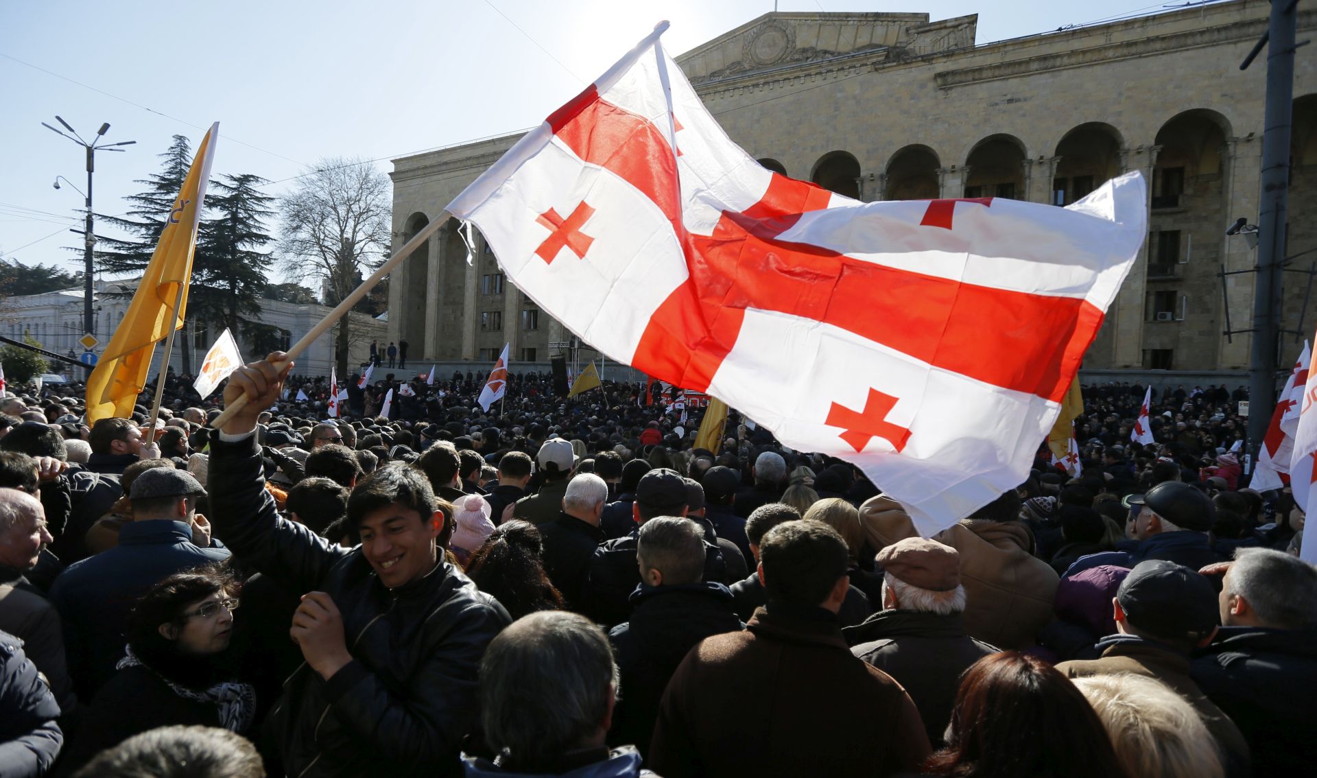 epa05804115 A protester holds Georgian flag during a protest rally in front of the Parliament building to support the opposition TV channel Rustavi 2 in Tbilisi, Georgia, 19 February 2017. The rally is taking place to demand justice over the ongoing ownership dispute of Rustavi 2. Owners of Rustavi 2 are involved in a court battle with the channel's previous co-owner, Kibar Khalvashi, who is reported to be trying to regain control over the channel.  EPA/ZURAB KURTSIKIDZE