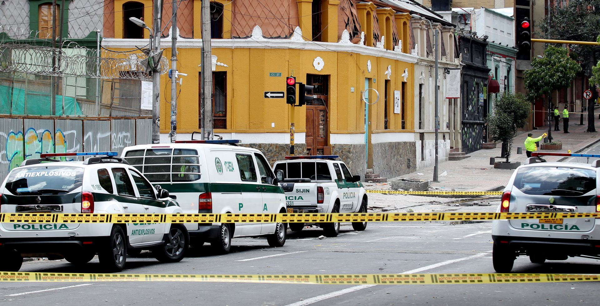 epa05804247 Members of the Colombian Police examine the area of an explosion in the La Macarena neighborhood of Bogota, Colombia, 19 February 2017. At least 31 people, most of them police officers, were injured by an explosion near the bullring in central Bogota. Police presence was high in the area as the last run of the bullfighting season in the Colombian capital was scheduled to be held the bullring La Santamaria.  EPA/Leonardo Munoz