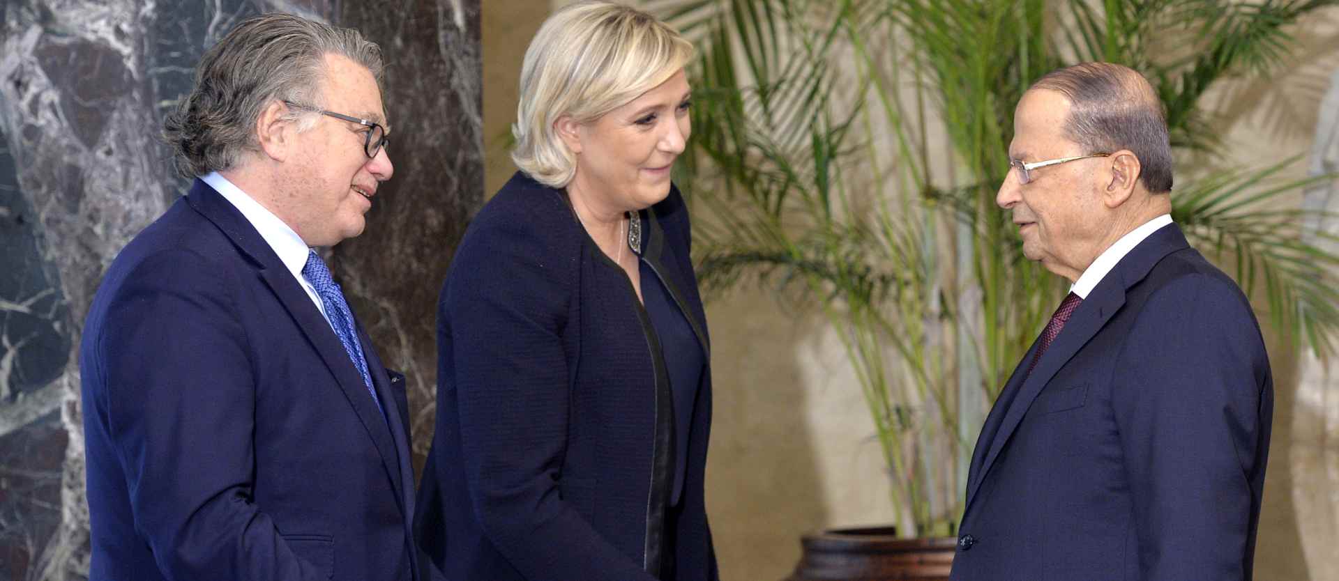 epa05805609 Lebanese President Michel Aoun (R) talks with the leader of France's far-right Front National political party and candidate for the 2017 French presidential elections Marine Le Pen (C) and French Gilbert Collard (L), lawyer and prominent member of Le Pen's party at the presidential palace in Baabda, east Beirut, Lebanon, 20 February 2017. Le Pen arrived in Beirut on 19 February for a three-day official visit to meet with the Lebanese officials.  EPA/WAEL HAMZEH