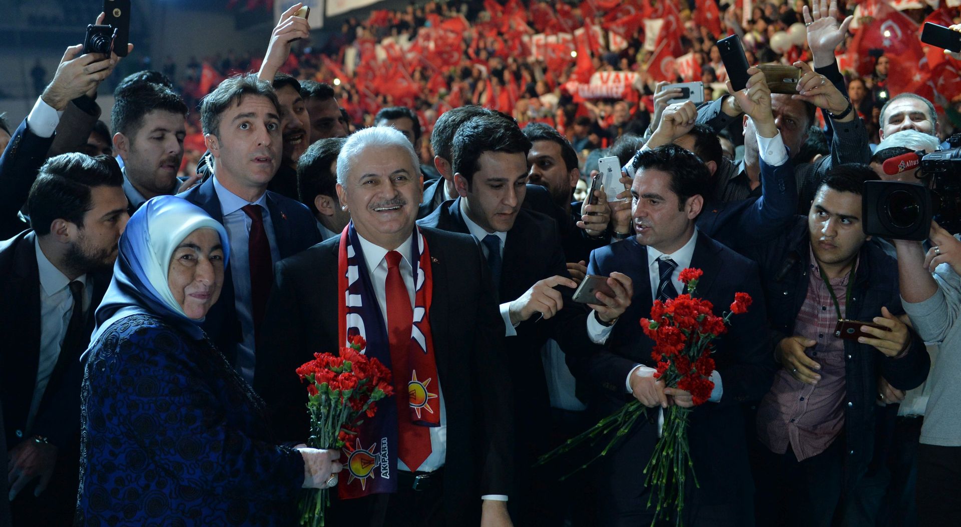 epa05813978 Binali Yildirim (2nd-L) Turkish Prime Minister and leader of the ruling Justice and Development Party (AKP) and  his wife Semiha (L), greet supporters during a 'Yes vote' campaign meeting for referendum in Ankara, Turkey 25 February 2017. Turkish parliament on 21 January approved a reform of the constitution to change the country's parliamentarian system of governance into a presidential one, which the opposition denounced as giving more power to Turkish president Recep Tayyip Erdogan. A referendum on the amendments is expected to be held in April.  EPA/STR