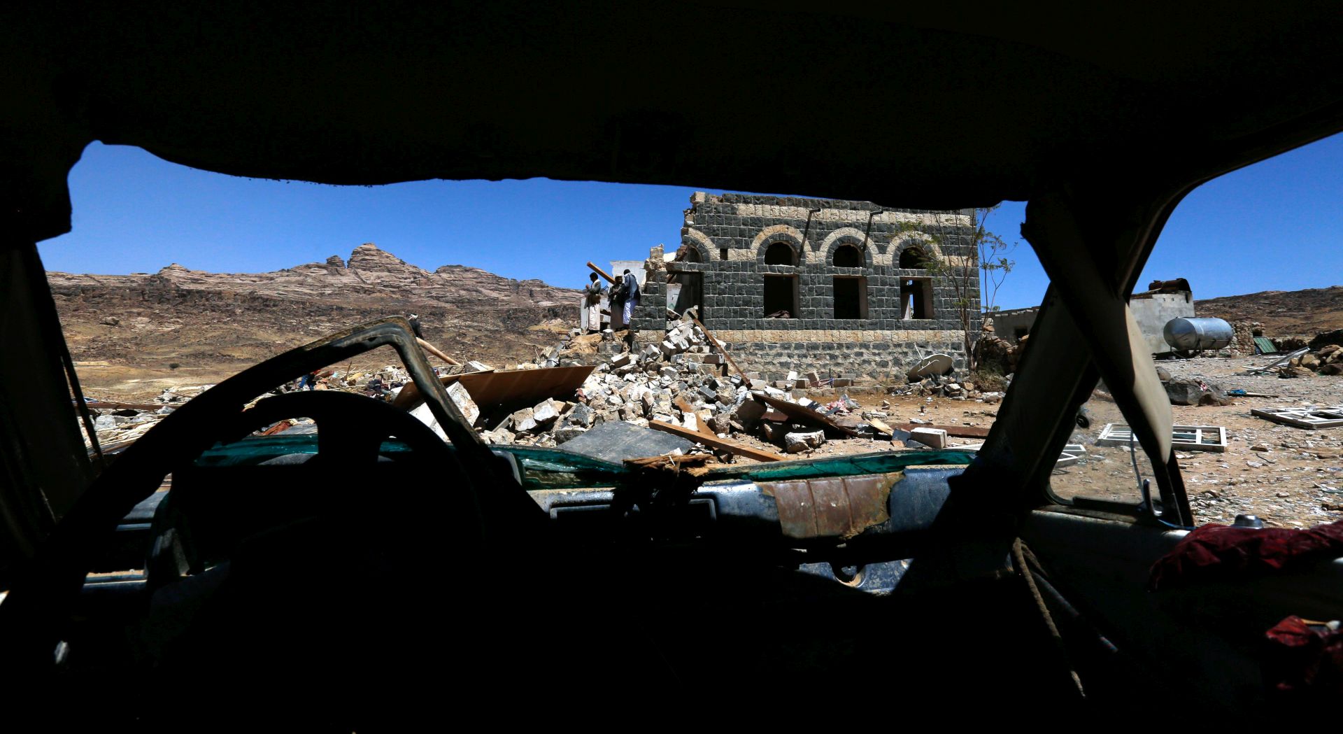 epa05797191 Yemenis inspect a destroyed house after an alleged Saudi-led airstrike hit a funeral reception on the northern outskirts of Sanaa, Yemen, 16 February 2017. According to reports, eight Yemeni women and a child have reportedly been killed and at least 10 more women wounded in an overnight airstrike allegedly carried out by the Saudi-led coalition a funeral reception near Yemen's rebel-held capital Sana'a.  EPA/YAHYA ARHAB