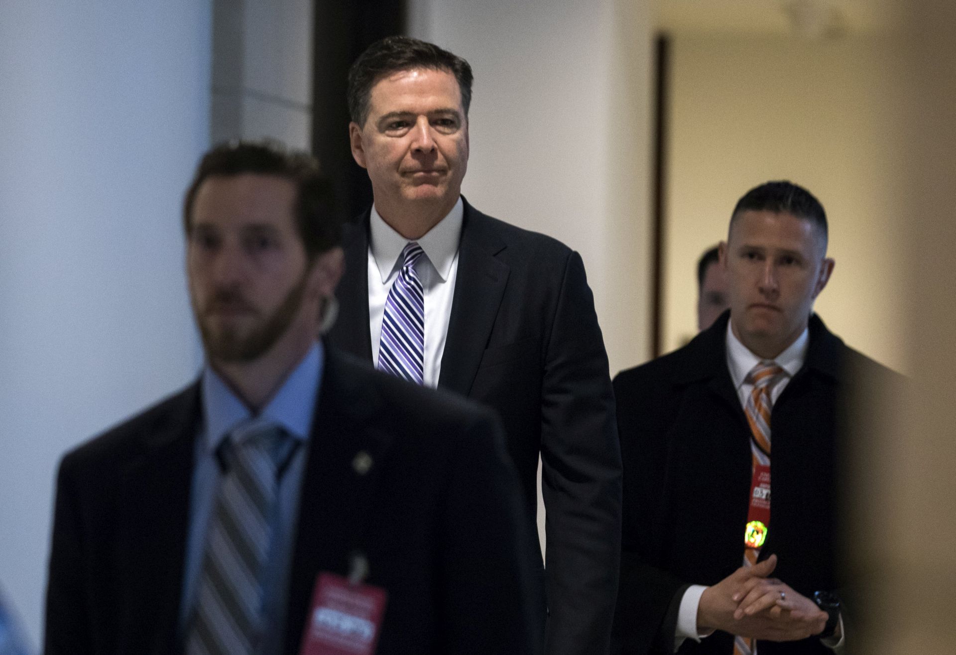 epa05850849 FBI Director James Comey (C) departs a meeting with members of Congress at the US Capitol in Washington, DC, USA, 15 March 2017. Lawmakers have said they have seen no evidence to back US President Donald J. Trump's claim that then President Obama wiretapped him.  EPA/JIM LO SCALZO