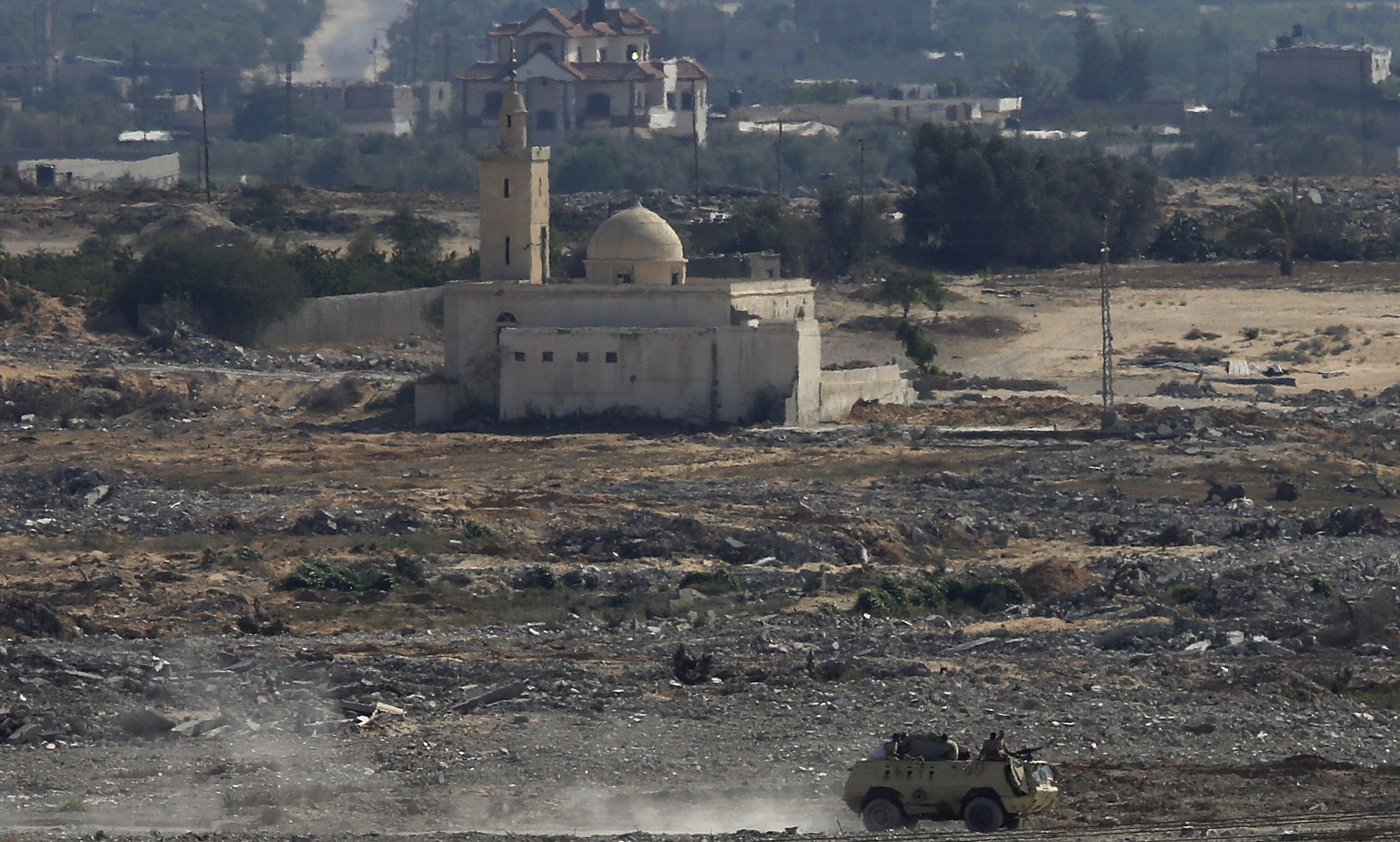 epa04828565 An Egyptian military vehicle patrols on Egypt's side of the border with southern Gaza Strip, near Rafah in the Gaza Strip, 02 July 2015. Security forces in Egypt's restive Sinai Peninsula have been targeted on 01 July in a spate of audacious attacks that analysts said marked an unprecedented tactic by a local Islamic State affiliate. There were conflicting reports about casualties from the synchronized attacks on security checkpoints and military facilities in the town of Sheikh Zuweid in northern Sinai. The military said that 'terrorist groups' attacked a number of positions in the Sheikh Zuweid and Rafah areas at 6.55 am local time (0455 GMT) on 01 July.  EPA/MOHAMMED SABER
