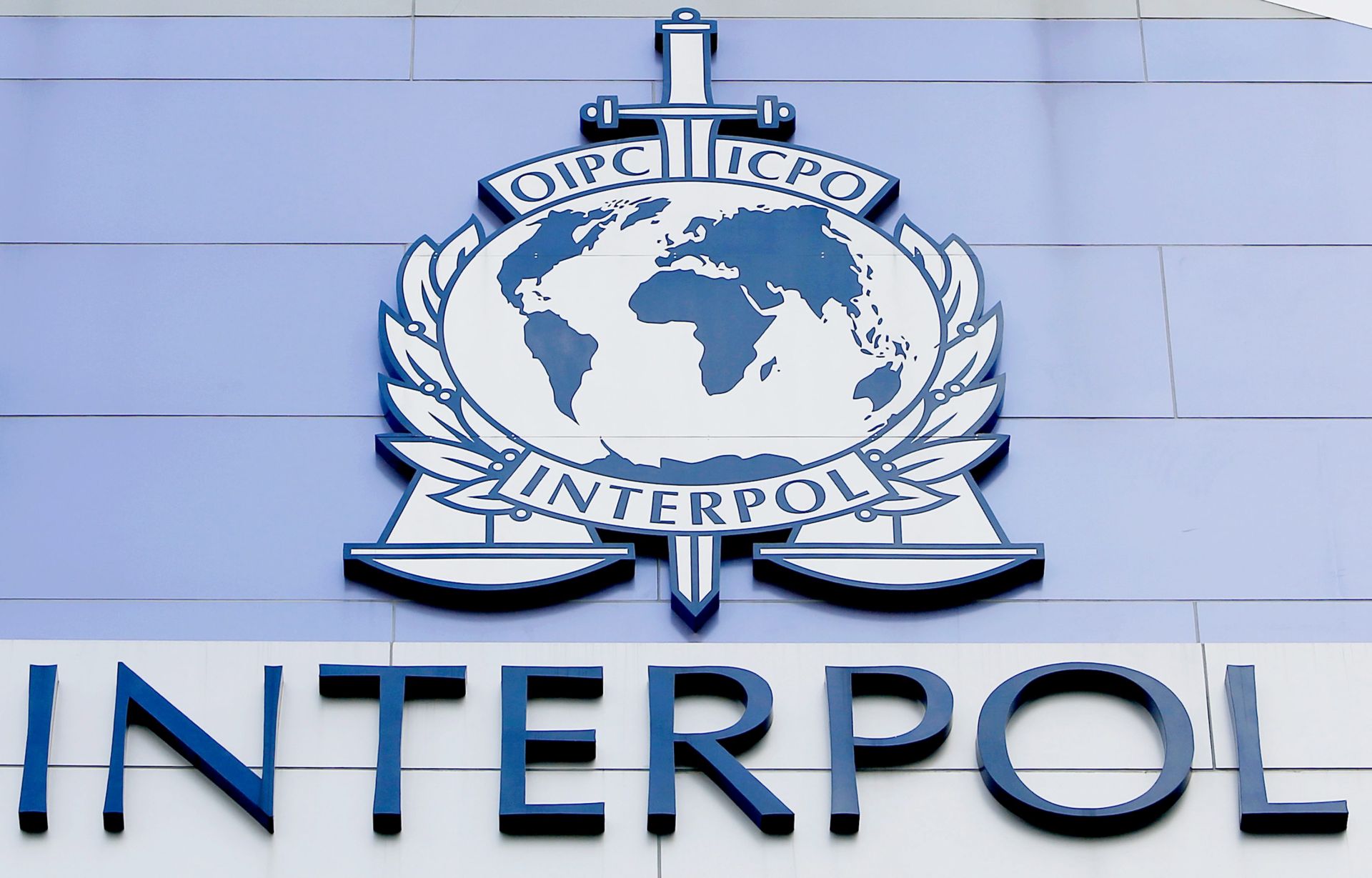 epa05018137 (FILE) A file photo dated 14 April 2015 of the 'Interpol' on a facade of the Interpol Global Complex for Innovation building (IGCI) in Singapore. Media reports on 09 November 2015 state that Interpol - based in Lyon, France - is to lead a global investigation into an alleged international corruption scam involving athletes and officials. Interpol's announcement followed a news conference in which an independent commission set up by the World Anti-Doping Agency (WADA) published a damning report on the Russian athletics federation for the use of systematic doping.  EPA/WALLACE WOON