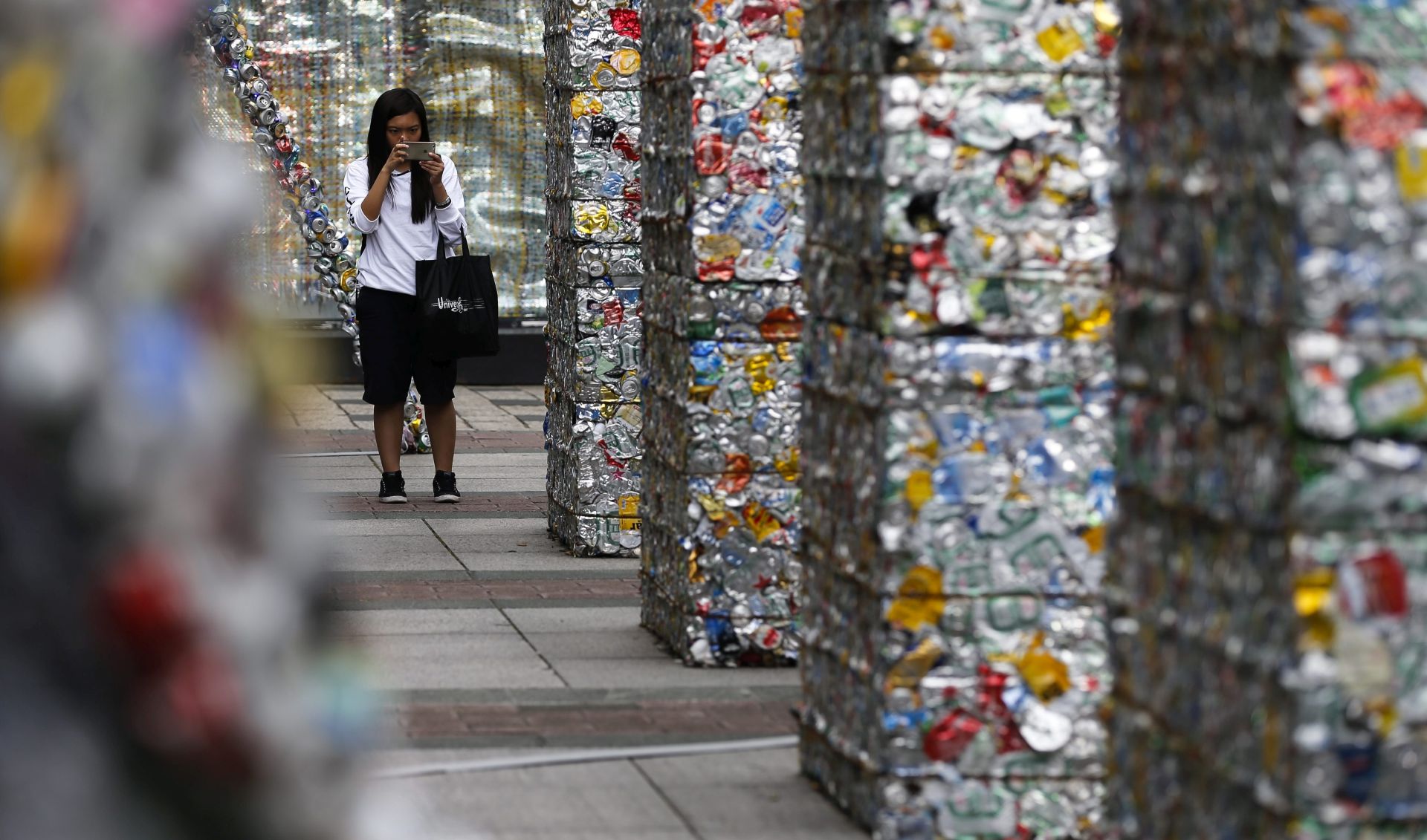 epa05271925 A visitor takes a photo of art installation made from discarded aluminum cans during the Earth day celebration in Taipei, Taiwan, 22 April 2016. Earth Day is celebrated annually on 22 April, to raise awareness and develop a sense of public responsibility pertaining to environmentally-sustainable practices in order to build and maintain a healthy, global ecosystem and maintain a viable planet for future generations.  EPA/RITCHIE B. TONGO