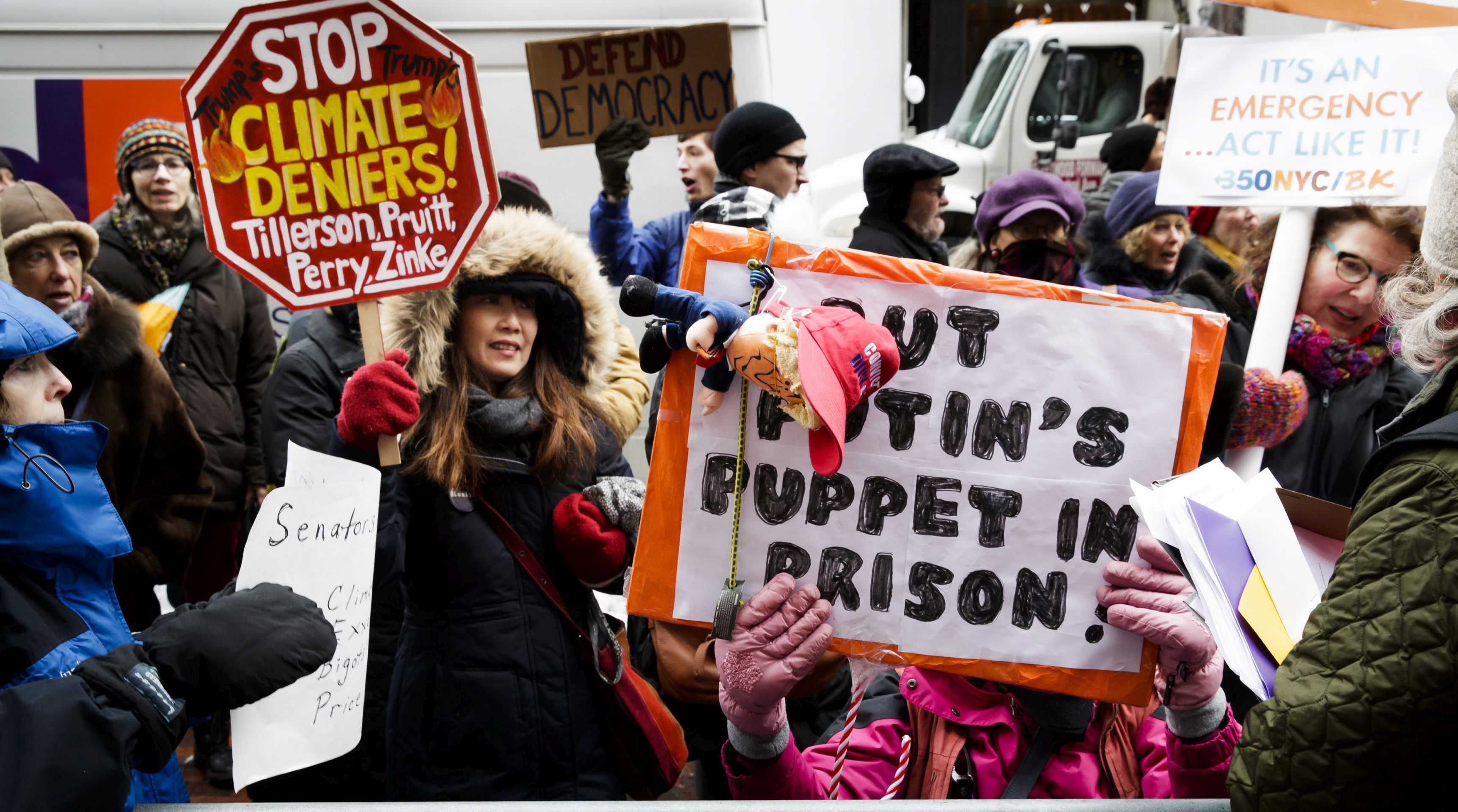 epa05708290 Protestors gather on the sidewalk in front of the offices of Senate Minority Leader Democrat Chuck Schumer as part of nationwide rally organized to protest the nominations of climate change deniers in the cabinet of US President-elect Donald Trump, New York, New York, 09 January 2017. The United States Senate is scheduled to begin confirmation hearings for Trump's cabinet nominees this week.  