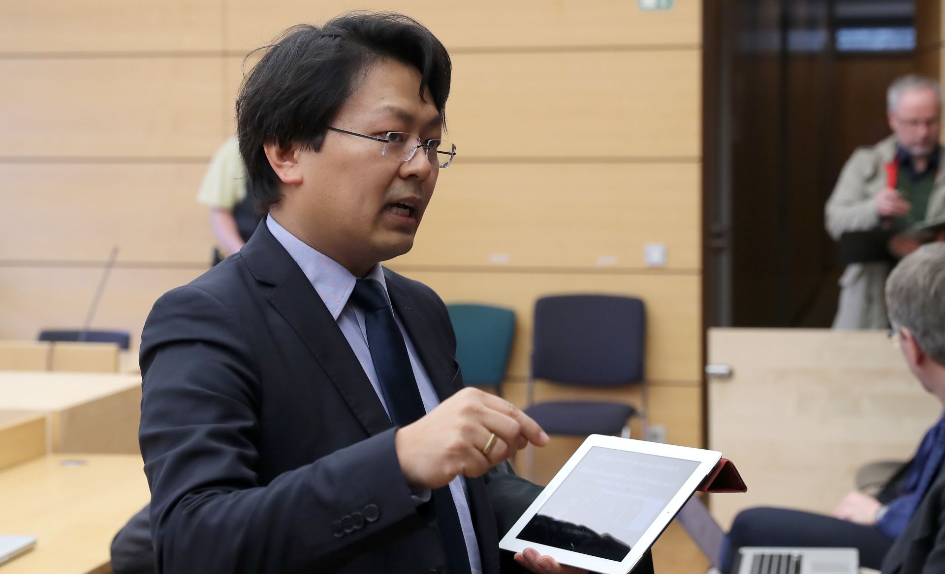 Lawyer Chan-jo Jun stands in the court room of the regional court in Wuerzburg, Germany, 7 March 2017. Jun represents a Syrian refugee who filed a restraining order against the social network Facebook. Facebook still does not have to look for illegal content against a refugee and delete it. The Syrian refugee Anas M., whose selfie with chancellor Angela Merkel was used for hateful comments and wrongful accusations, was not successful in filing a restraining order against the internet giant. He has to continue searching for defamatory content against himself and report it. Photo: Daniel Karmann/dpa