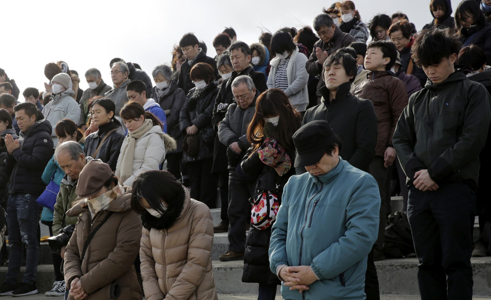 epa05841916 People on newly constructed tsunami surge barrier offer one-minute silent prayers for victims killed by the magnitude 9.0 earthquake and tsunami of 11 March 2011 at Arahama in Sendai, Miyagi Prefecture, northern Japan, 11 March 2017. Japan marked the sixth anniversary of the earthquake and tsunami devastating northern Japan and Fukushima Daiichi Nuclear Power Plant on 11 March 2017. About 20,000 people were killed and missing by the earthquake and tsunami. In Miyagi Prefecture, more than 10,000 people were killed or missing.  EPA/KIMIMASA MAYAMA