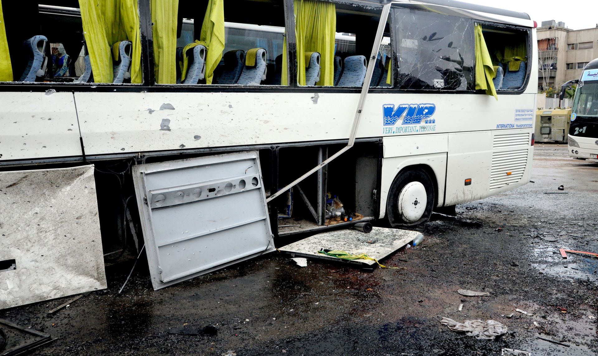 epa05842320 A handout photo made available by the Syrian Arab News Agency (SANA) shows a damaged bus at the site of bombing, in Damascus, Syria, 11 March 2017. According to reports, at least 44 people were killed and scores injured in a double bombing attack on buses of Shiite pilgrims parked outside a cemetery in central Damascus.  EPA/SANA HANDOUT  HANDOUT EDITORIAL USE ONLY/NO SALES