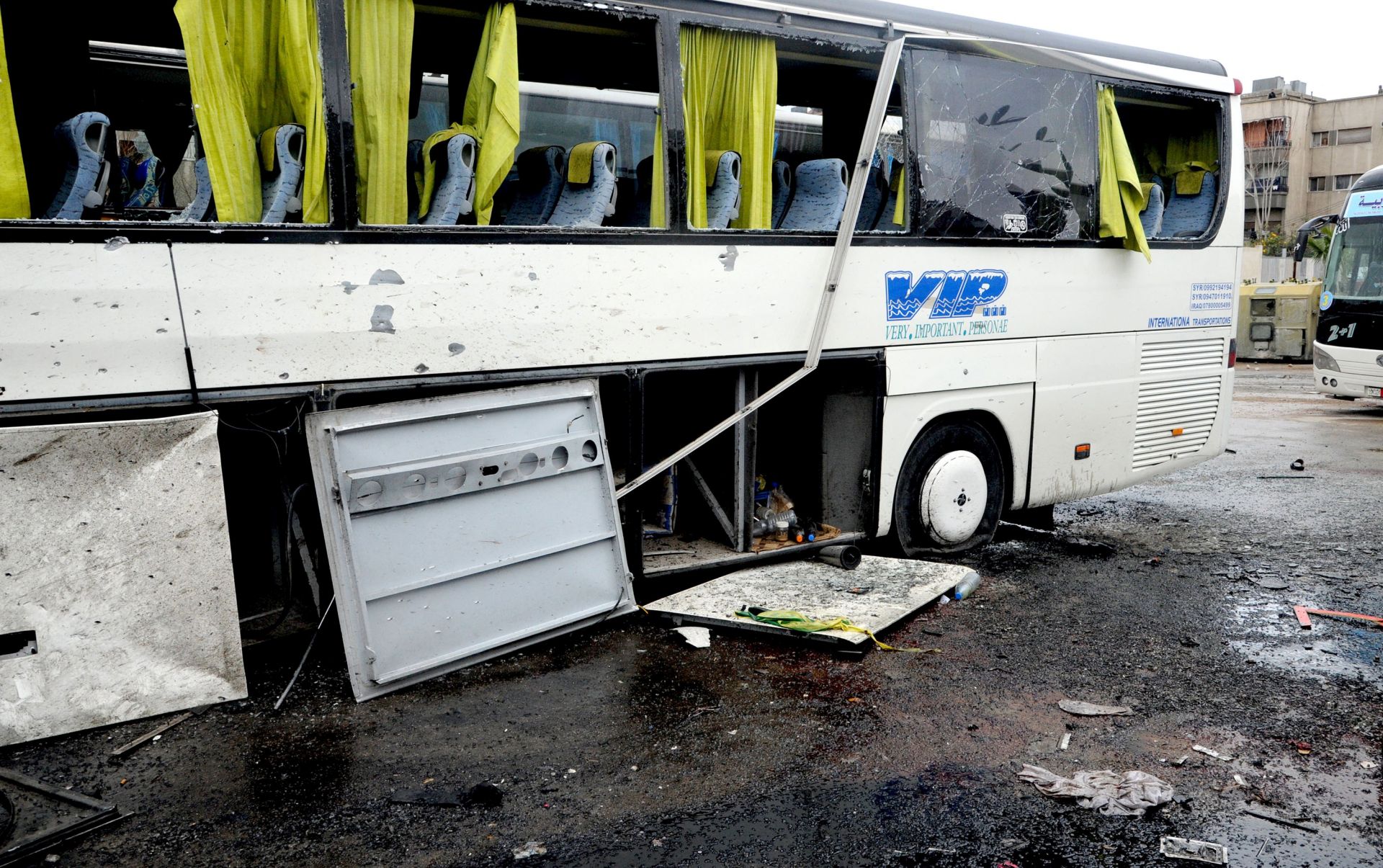 epa05842320 A handout photo made available by the Syrian Arab News Agency (SANA) shows a damaged bus at the site of bombing, in Damascus, Syria, 11 March 2017. According to reports, at least 44 people were killed and scores injured in a double bombing attack on buses of Shiite pilgrims parked outside a cemetery in central Damascus.  EPA/SANA HANDOUT  HANDOUT EDITORIAL USE ONLY/NO SALES