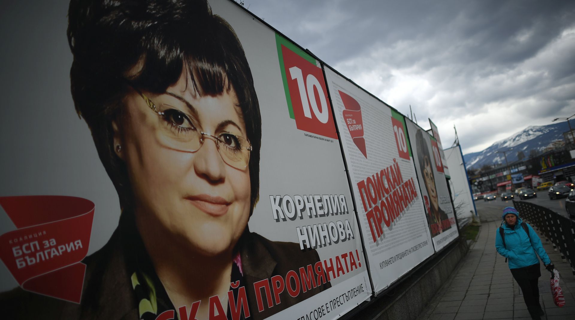 epa05857510 A man passes in front of election posters supporting Kornelia Nina leader of the Bulgarian Socialist Party (BSP) in Sofia, Bulgaria, 19 March 2017. Bulgaria holds an early parliamentary elections on 26 March 2017.  EPA/VASSIL DONEV